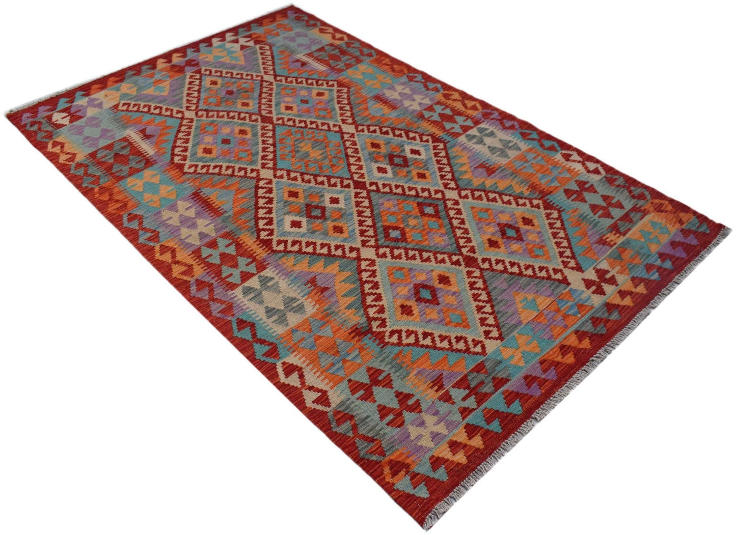 Handwoven Afghan Maimana kilim rug featuring a vibrant geometric diamond pattern in wool.