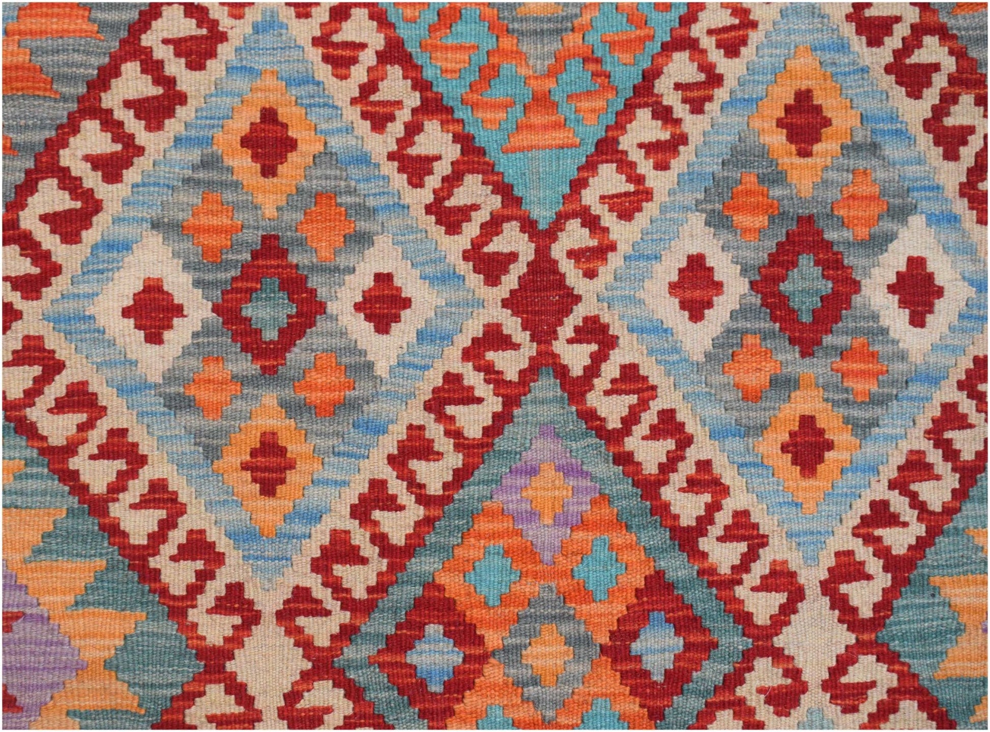 Handwoven Afghan Maimana kilim featuring a vibrant geometric diamond pattern in wool.