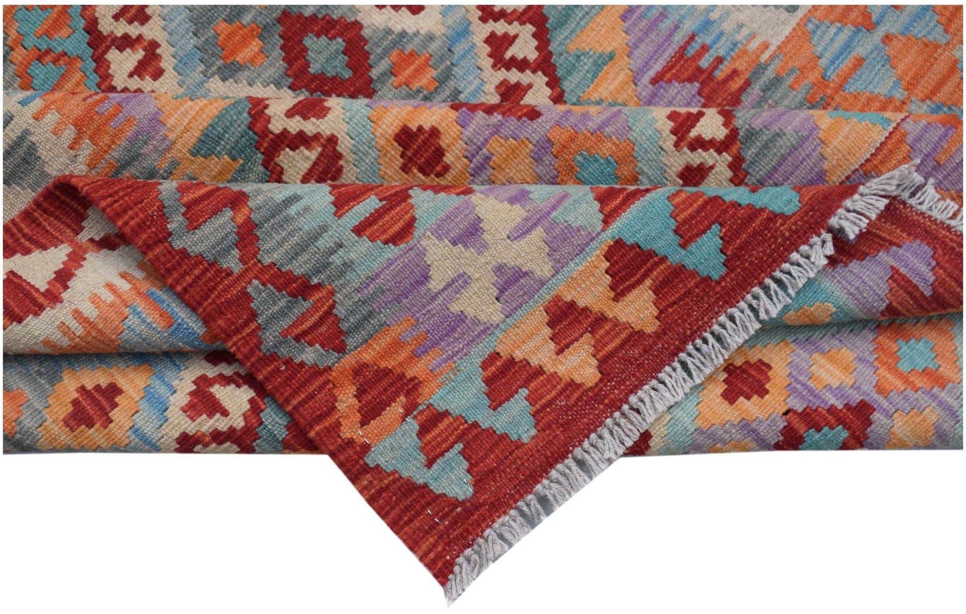 A handwoven Afghan Maimana kilim rug featuring a vibrant geometric pattern in wool.