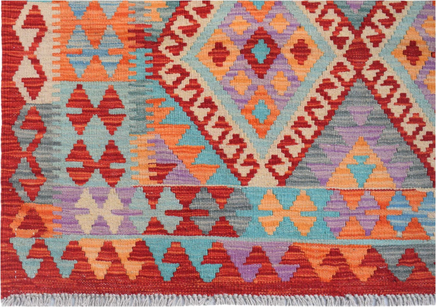 Handwoven Afghan Maimana kilim rug featuring a vibrant geometric pattern in wool.