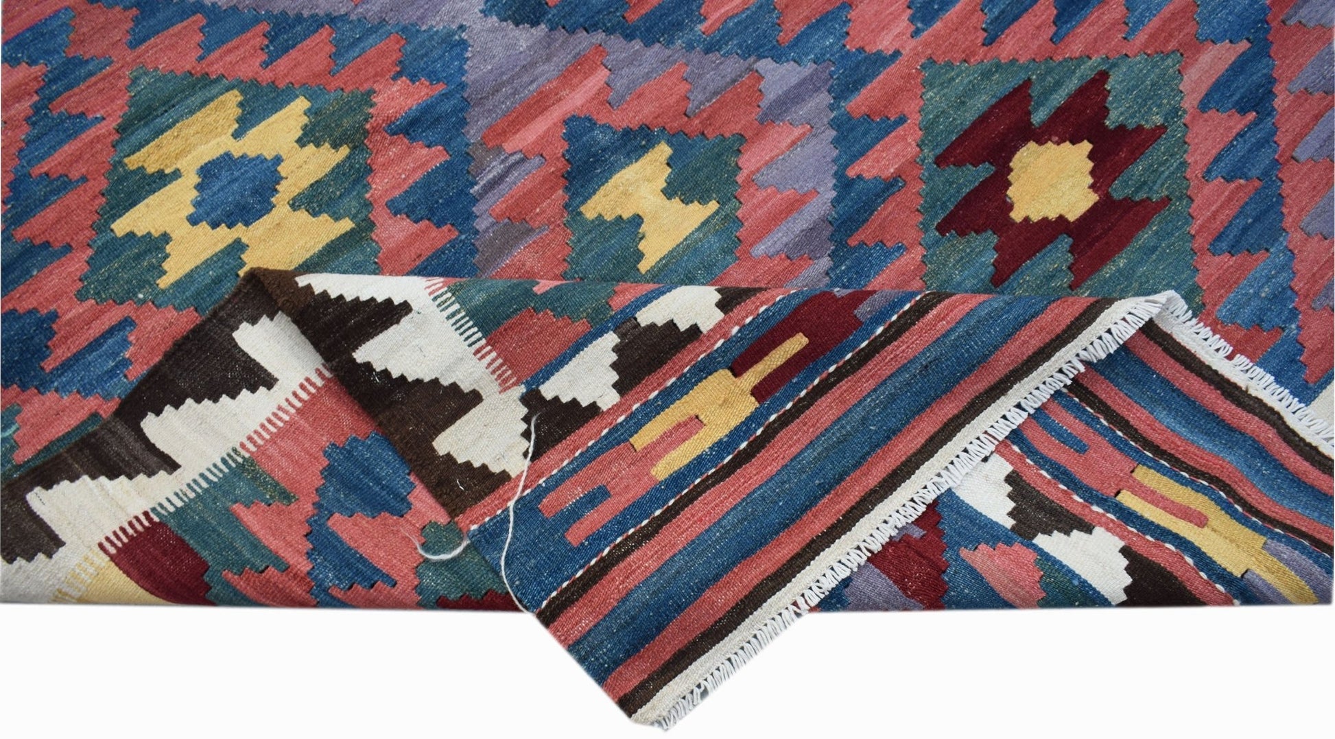 Handwoven Afghan Maimana kilim featuring a geometric pattern in blue, red, and yellow wool.