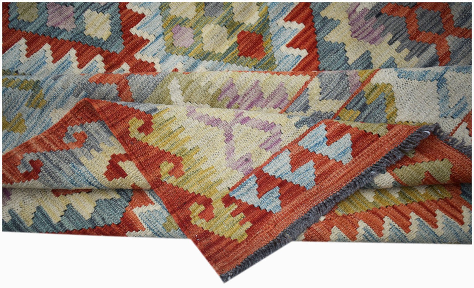 Handwoven Afghan Maimana kilim rug featuring a geometric pattern in red, blue, and yellow tones.
