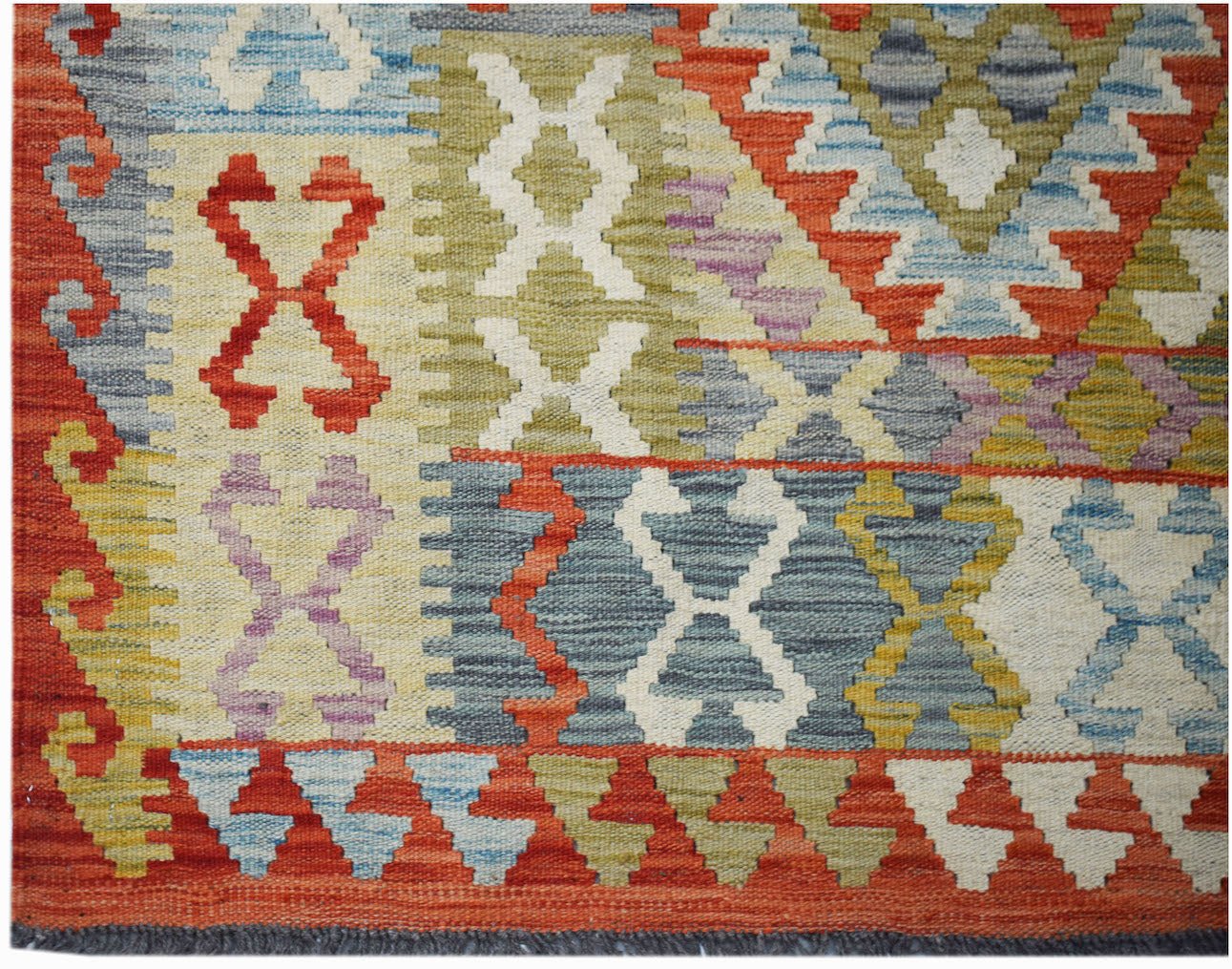 Handwoven Afghan Maimana kilim rug featuring a colorful geometric pattern in wool.