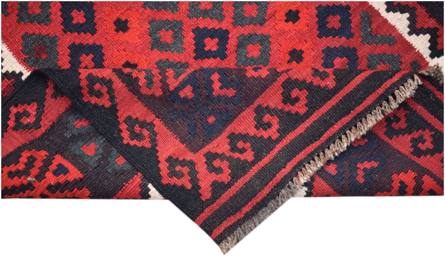 A handmade Afghan Maimana kilim featuring a geometric pattern in red and dark blue wool.