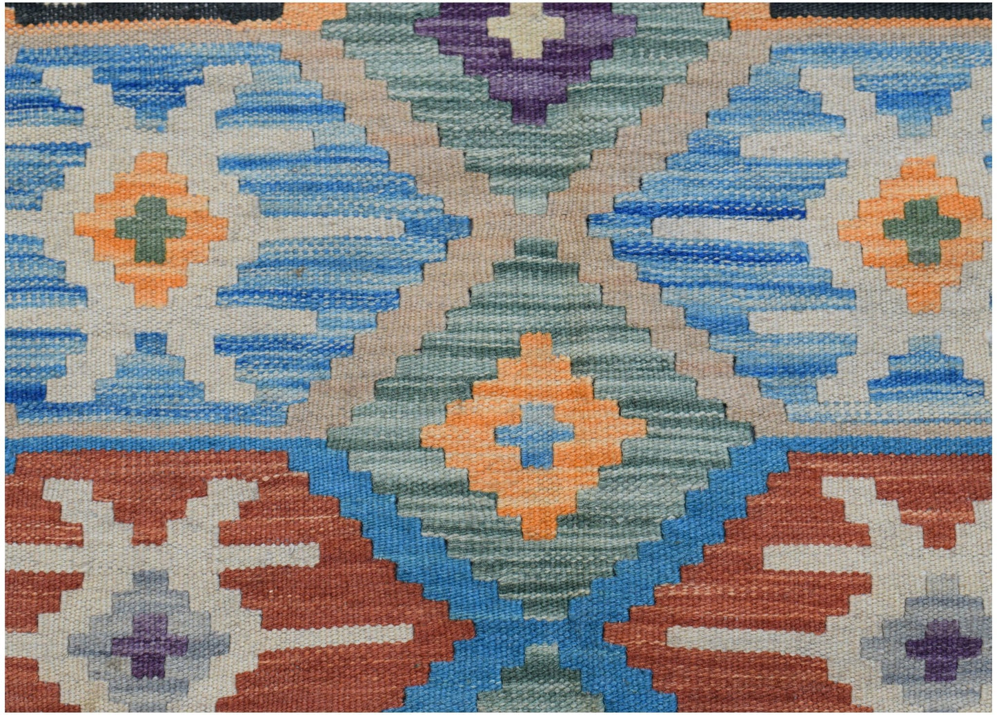 Handwoven Afghan Maimana kilim featuring a geometric pattern in blue, orange, and earthy tones.