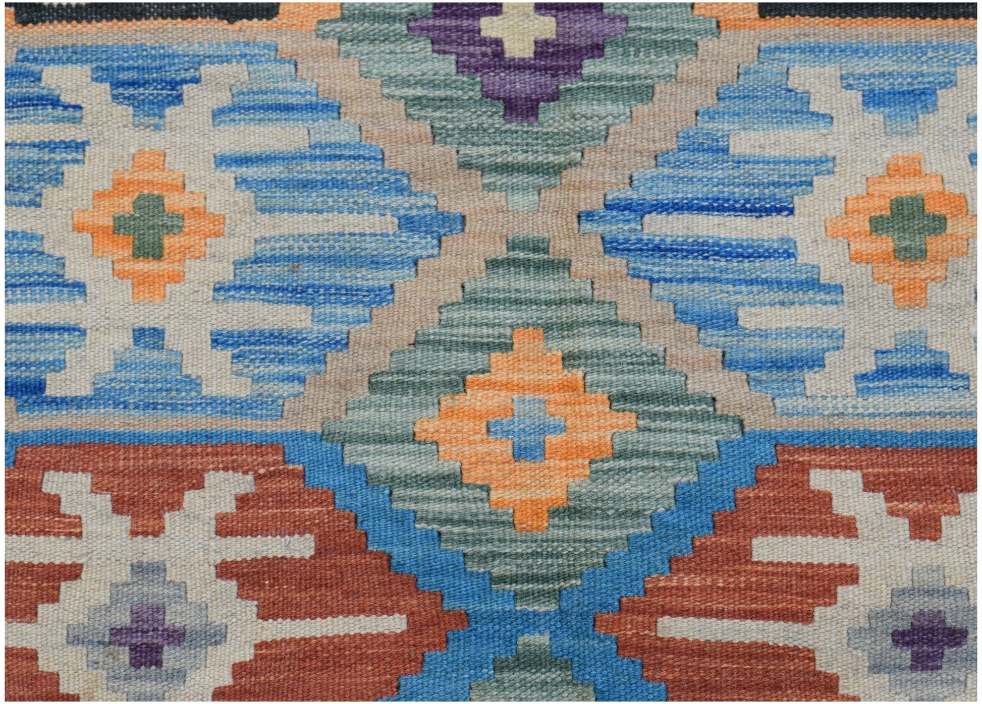Handwoven Afghan Maimana kilim featuring a geometric pattern in blue, orange, and earthy tones.