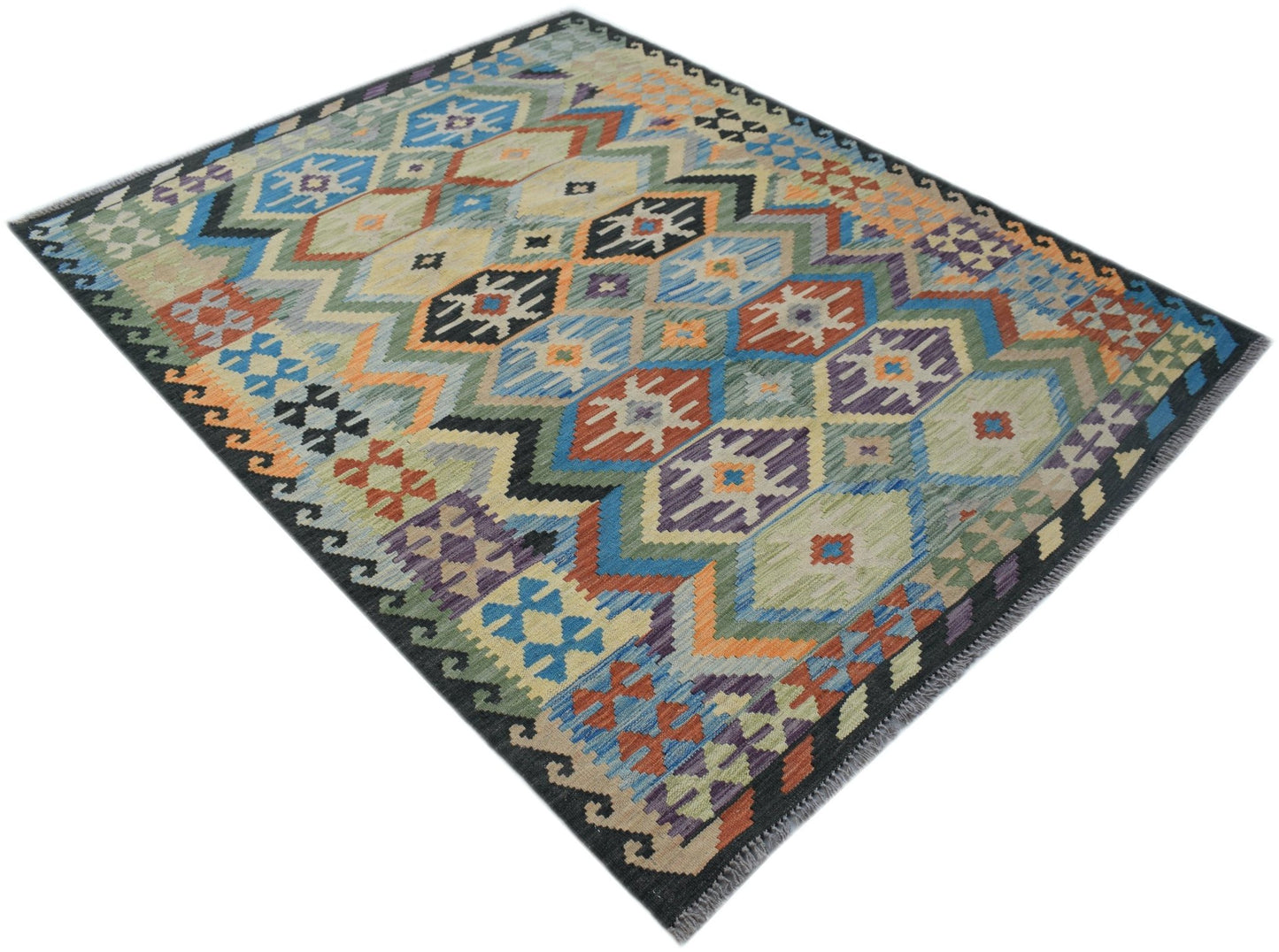 Handwoven Afghan Maimana kilim rug featuring a colorful geometric pattern on a flatweave wool base.