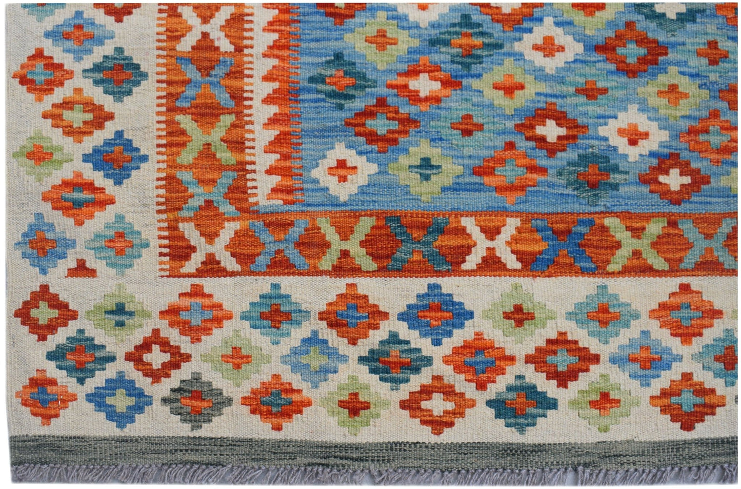 Handwoven Afghan Maimana kilim featuring a geometric pattern in blue, orange, and green wool.