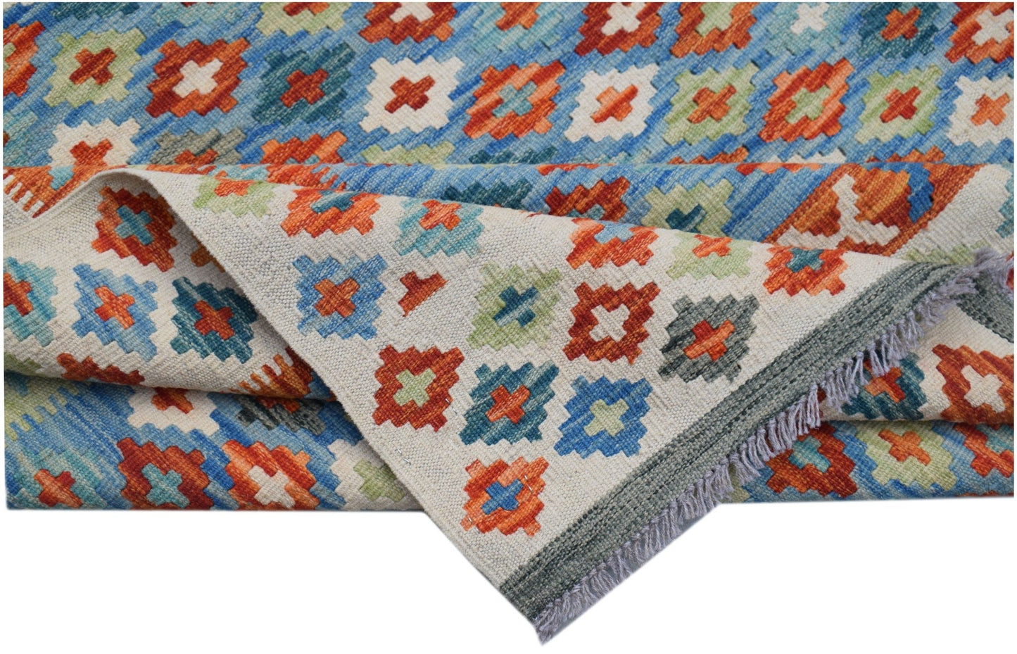 A handmade Afghan Maimana kilim rug featuring a colorful geometric pattern on a flatweave wool base.