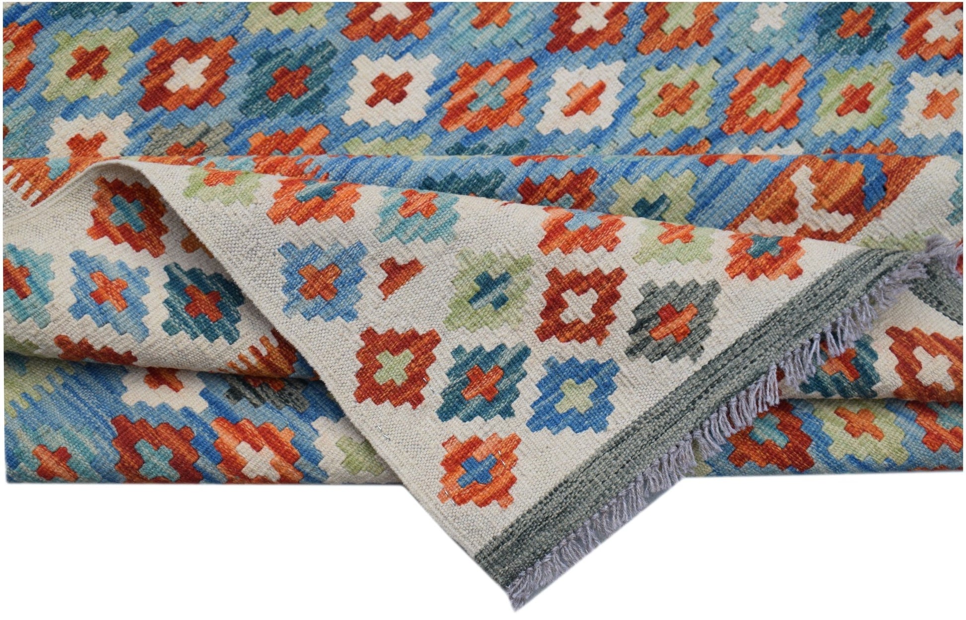 A handmade Afghan Maimana kilim rug featuring a colorful geometric pattern on a flatweave wool base.