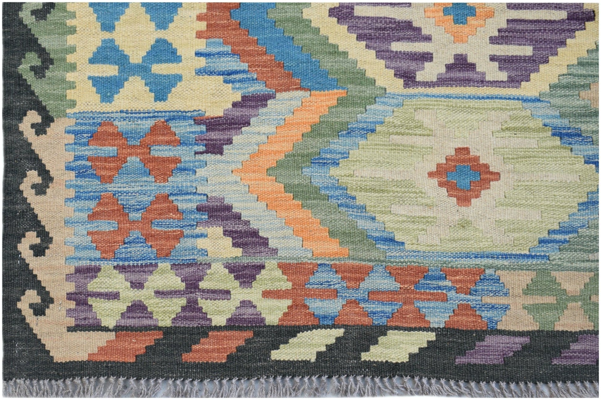 Handwoven Afghan Maimana kilim rug featuring a colorful geometric pattern on a wool flatweave.
