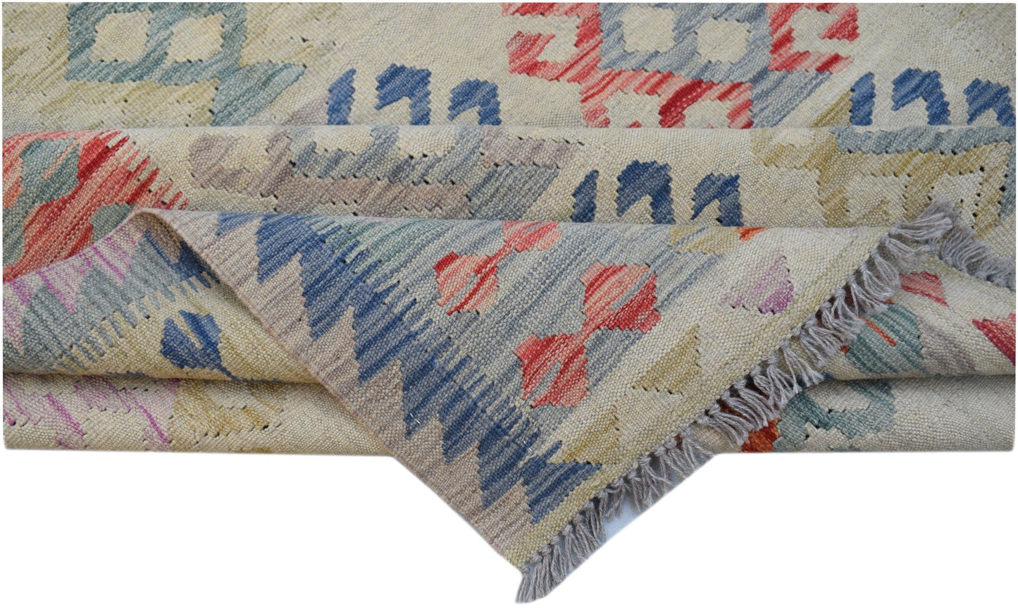 Handwoven Afghan Maimana kilim rug featuring geometric patterns in blue, red, and yellow wool.