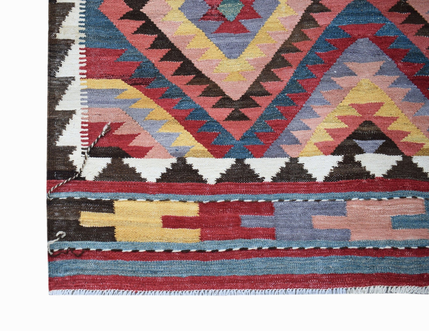 A handmade Afghan Maimana kilim featuring a vibrant geometric pattern in wool.