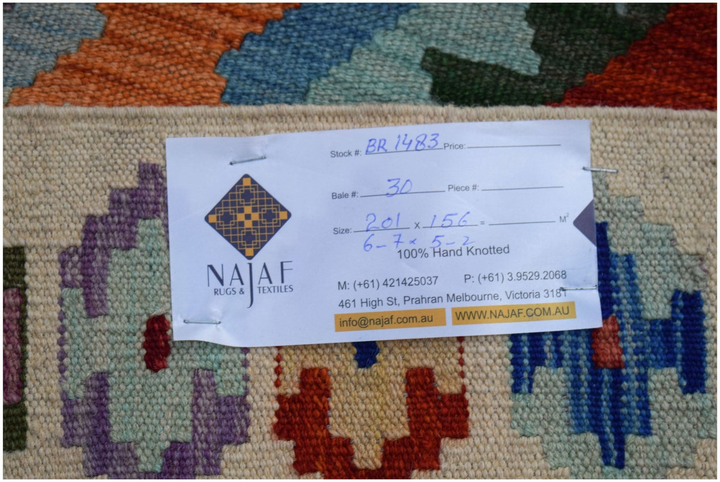 A handmade Afghan Maimana Kilim featuring a colorful geometric pattern on a flatweave wool surface.