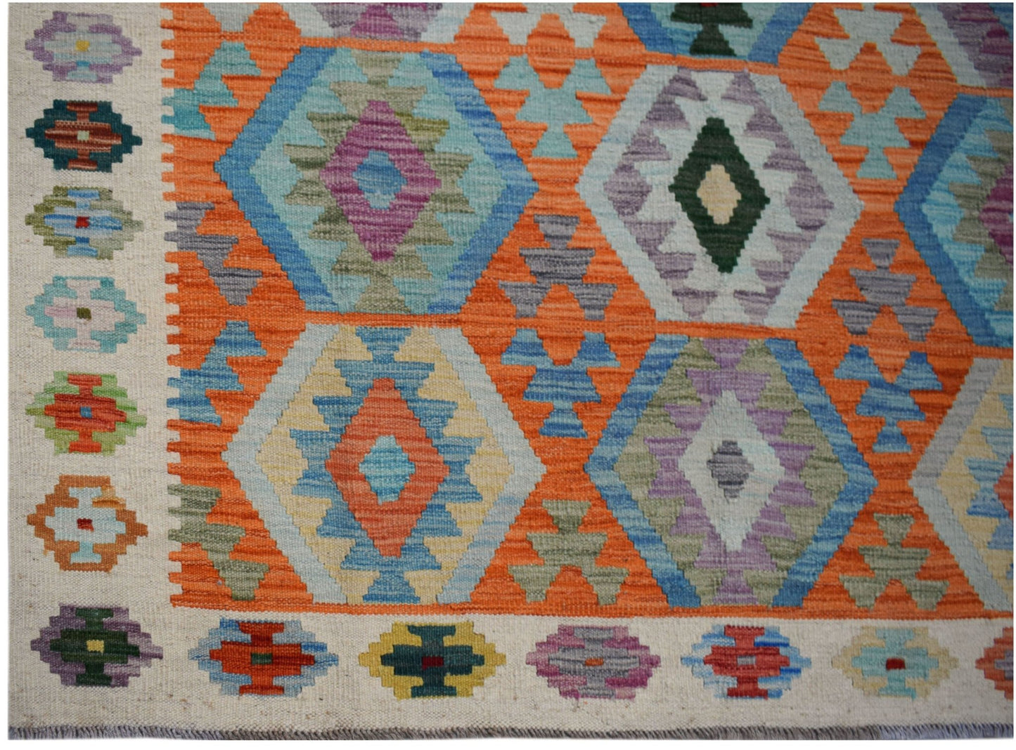 Handwoven Afghan Maimana kilim featuring a vibrant geometric pattern in wool.