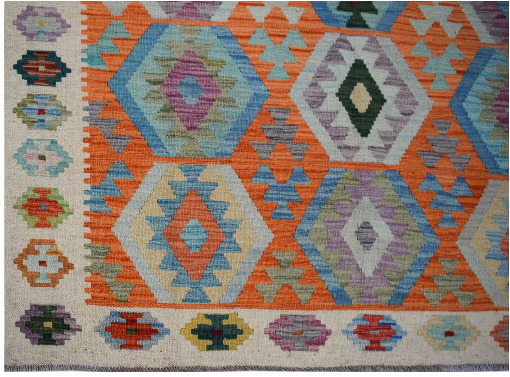 Handwoven Afghan Maimana kilim featuring a vibrant geometric pattern in wool.