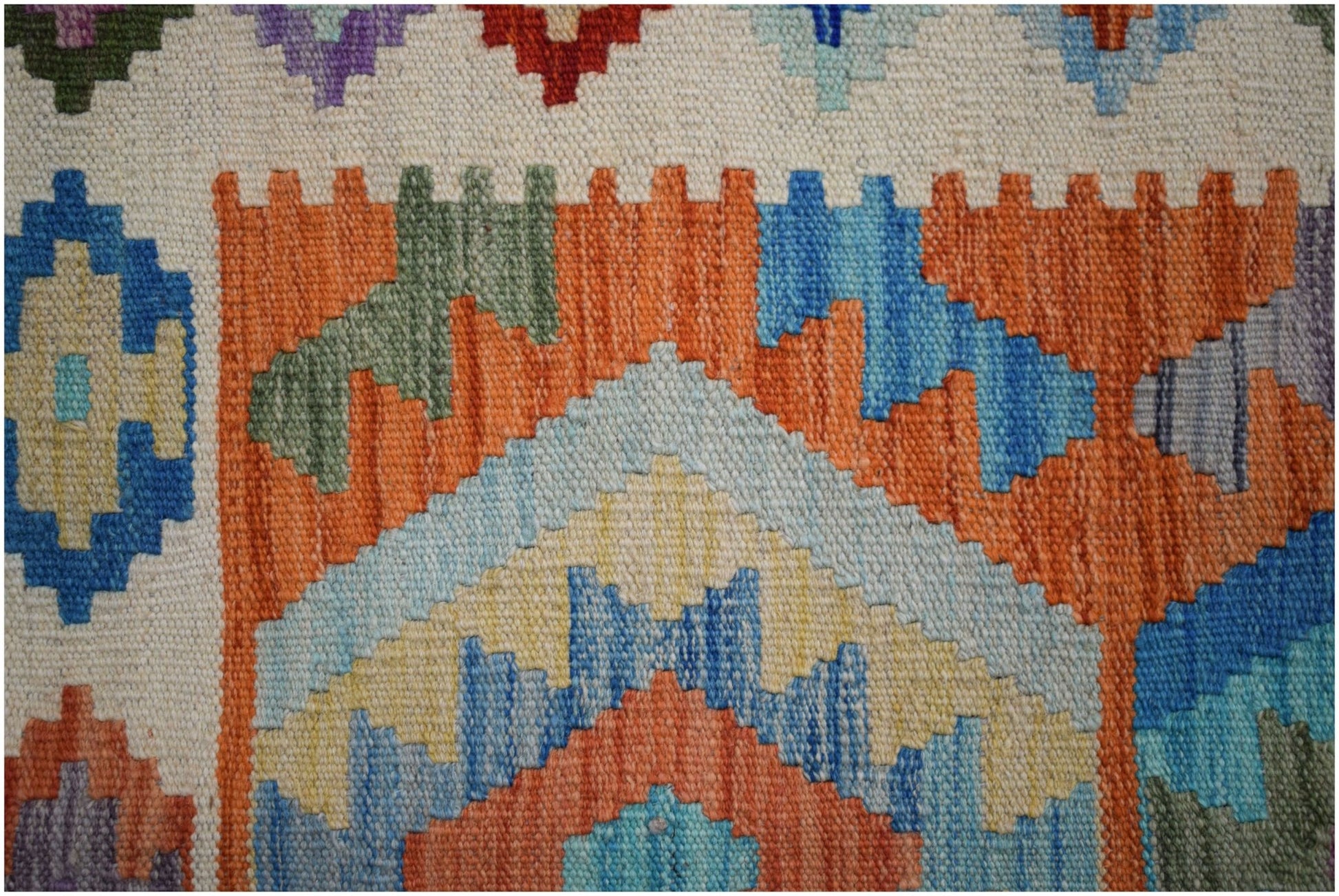 Handwoven Afghan Maimana Kilim featuring a vibrant geometric pattern in wool.