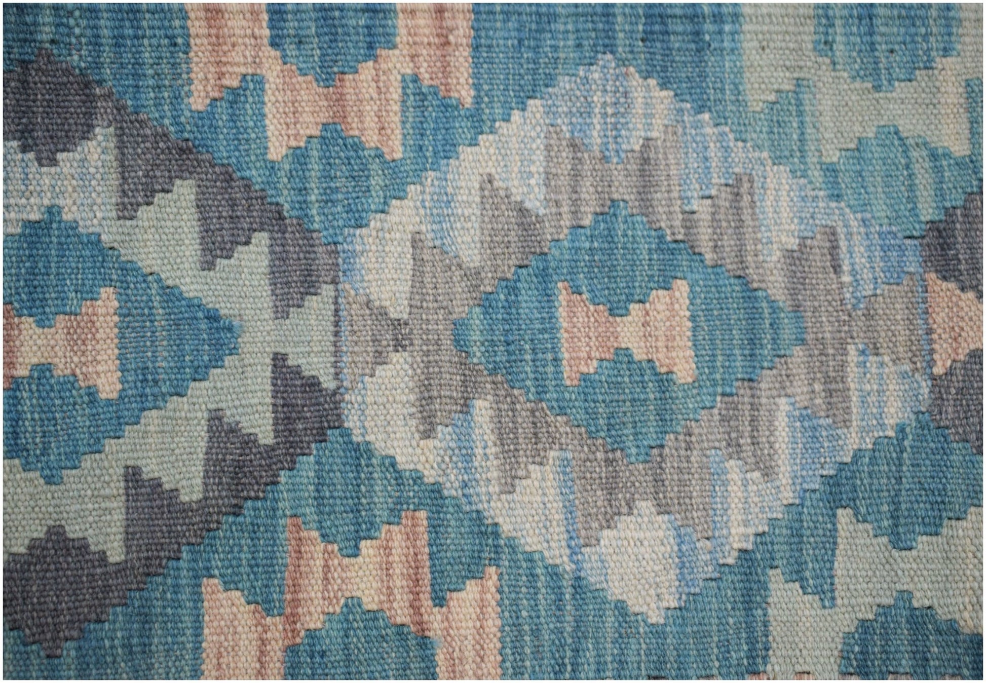 Handwoven Afghan Maimana kilim rug featuring a geometric diamond pattern in blue and beige tones.