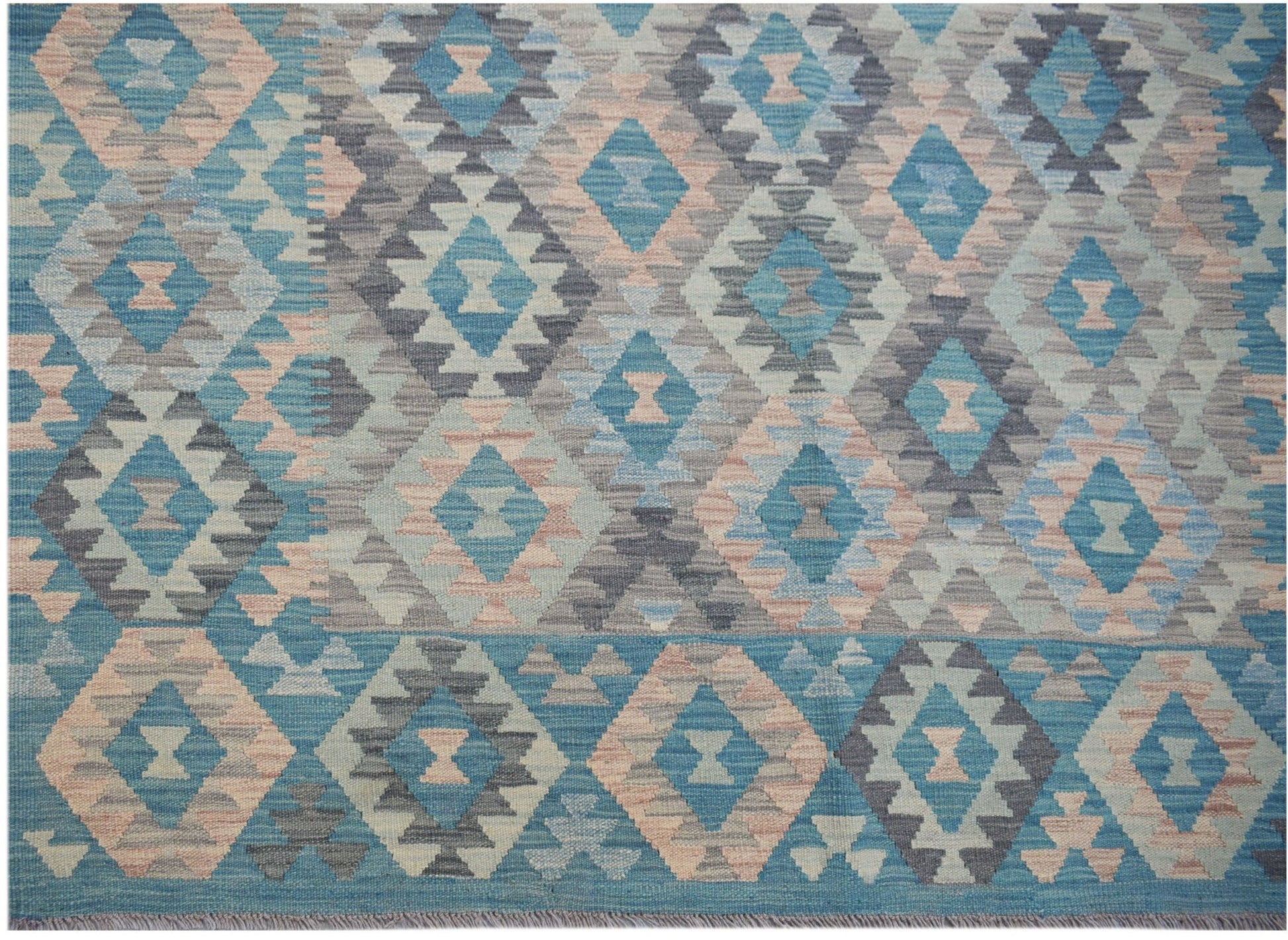 Handwoven Afghan Maimana Kilim rug featuring a geometric diamond pattern in blue and peach tones.
