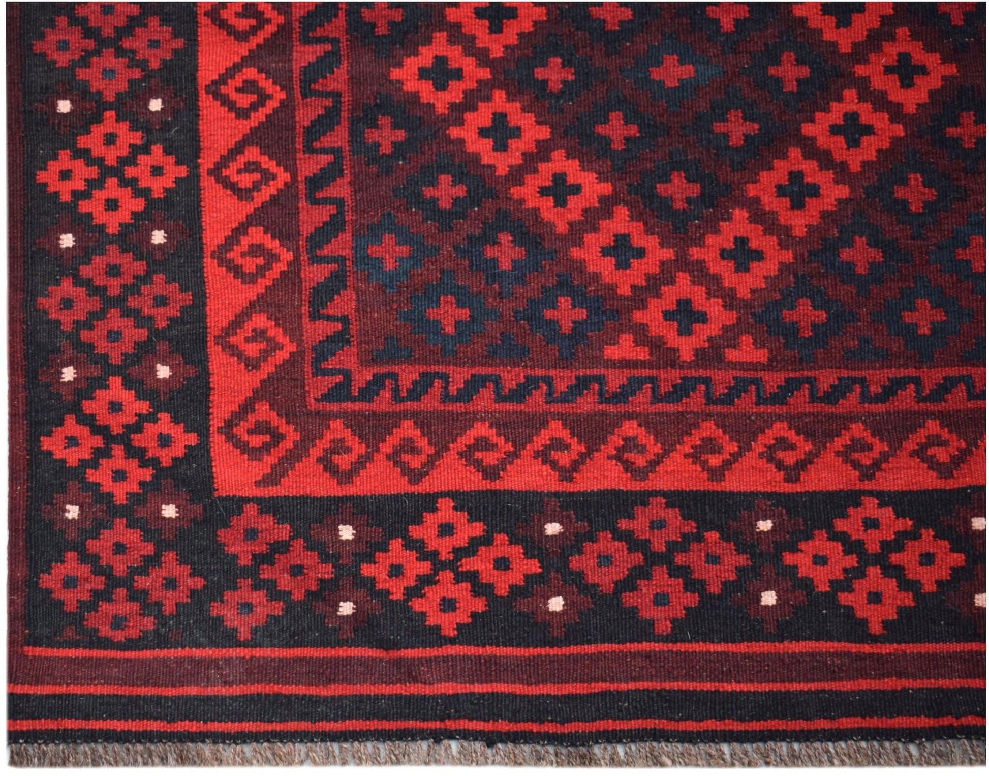 Handwoven Afghan Maimana Kilim rug featuring a geometric red and black pattern.