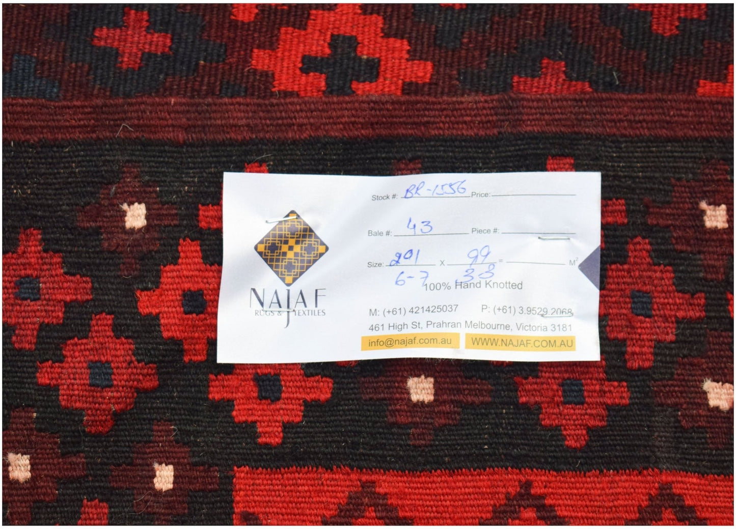 An Afghan Maimana kilim featuring a geometric pattern in red and black wool.