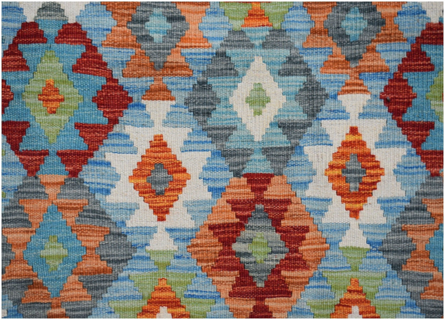 Handwoven Afghan Maimana kilim featuring a vibrant geometric diamond pattern in wool.