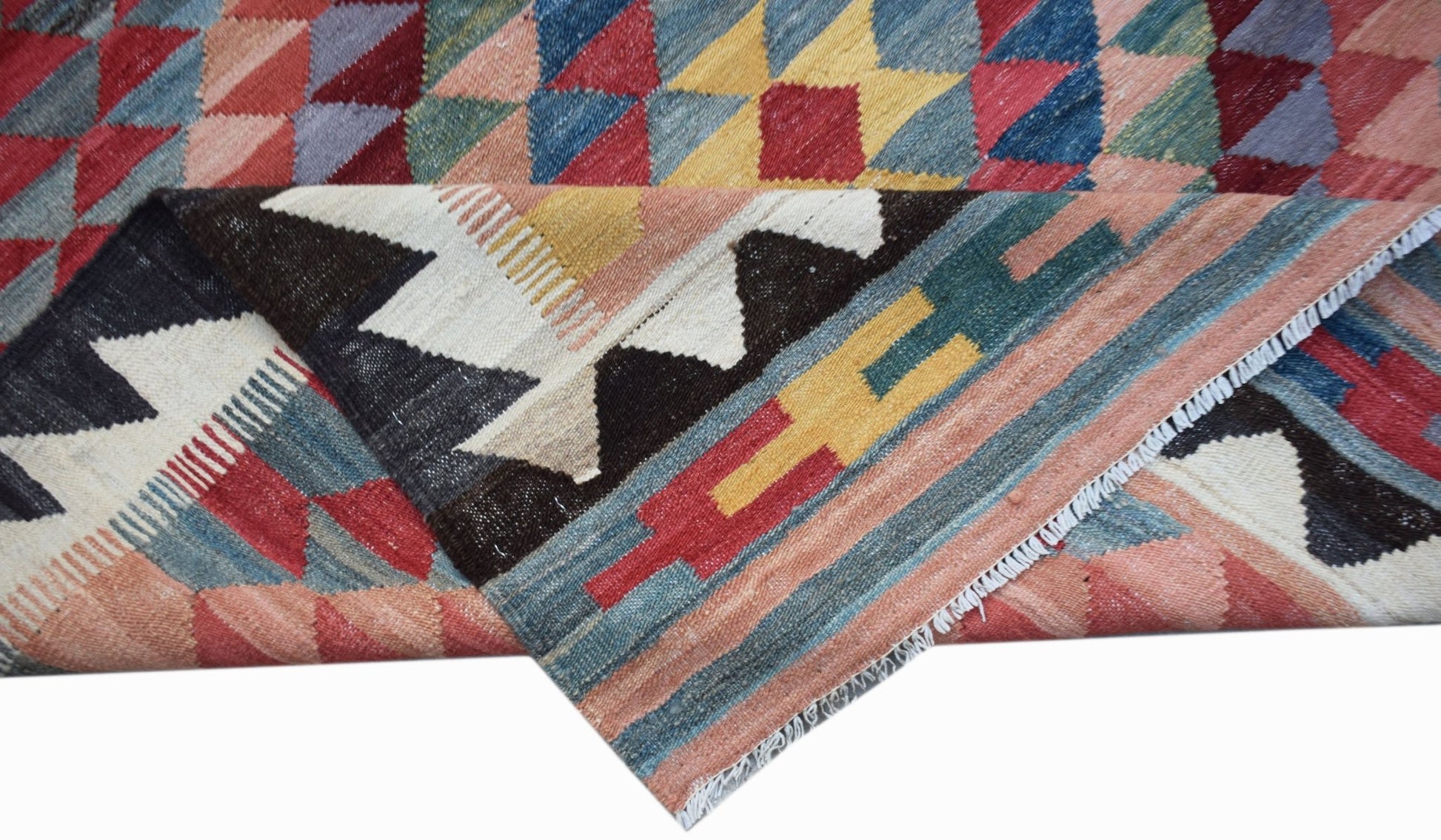 A handmade Afghan Maimana kilim rug featuring a geometric pattern in vibrant multicolored wool.