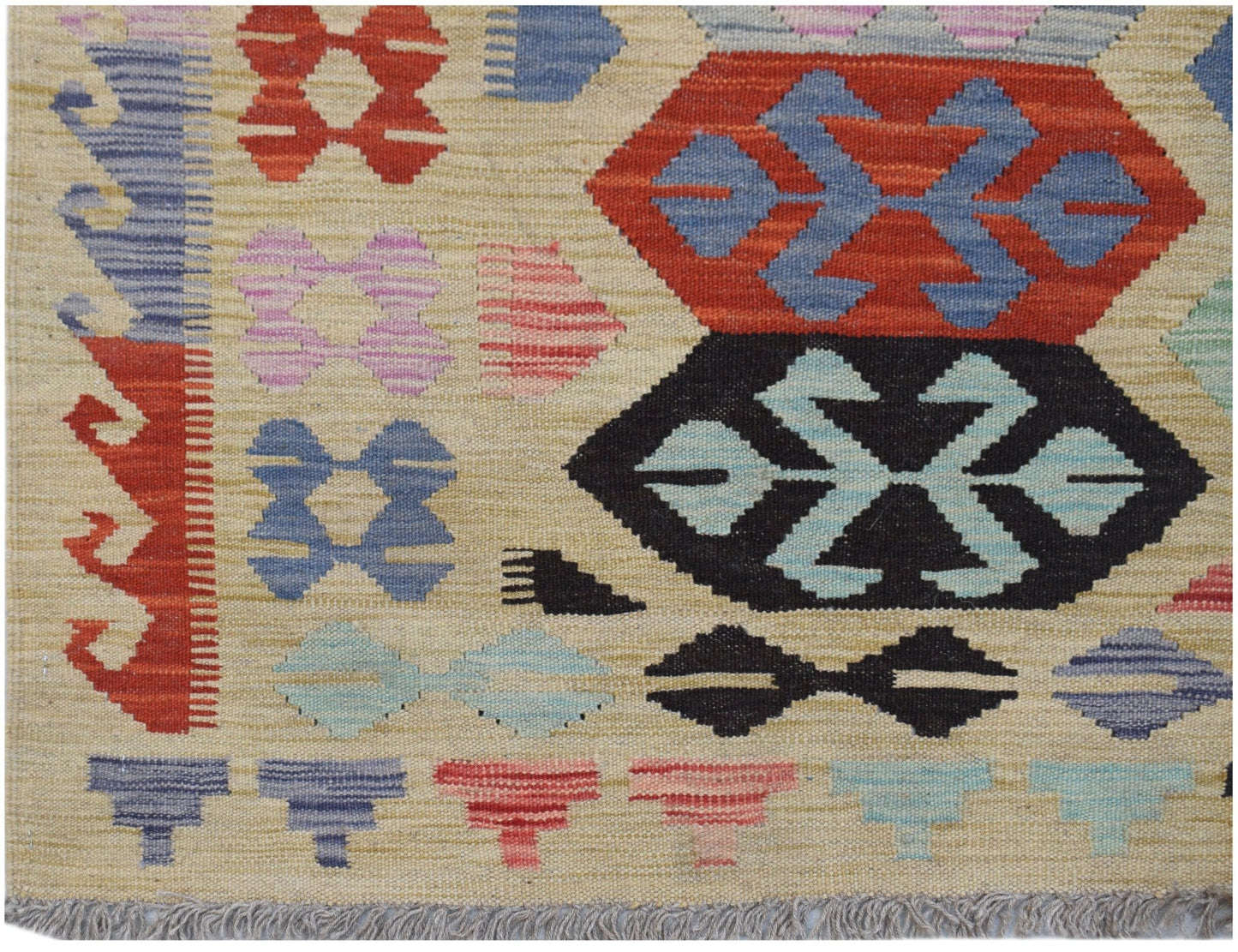 Handwoven Afghan Maimana kilim rug featuring geometric patterns in red, blue, and black wool.