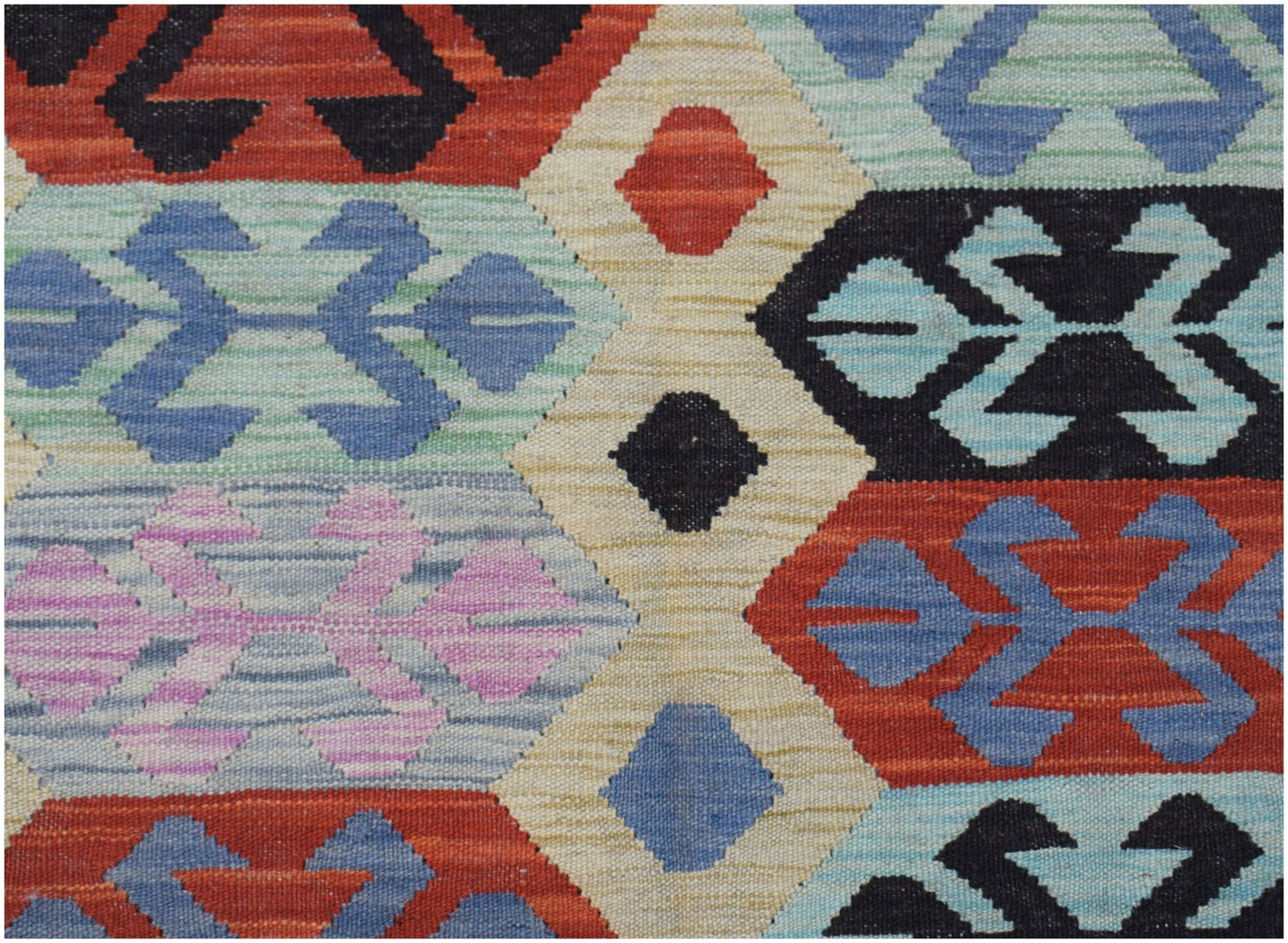 Handwoven Afghan Maimana Kilim featuring a geometric pattern in vibrant multicolored wool.
