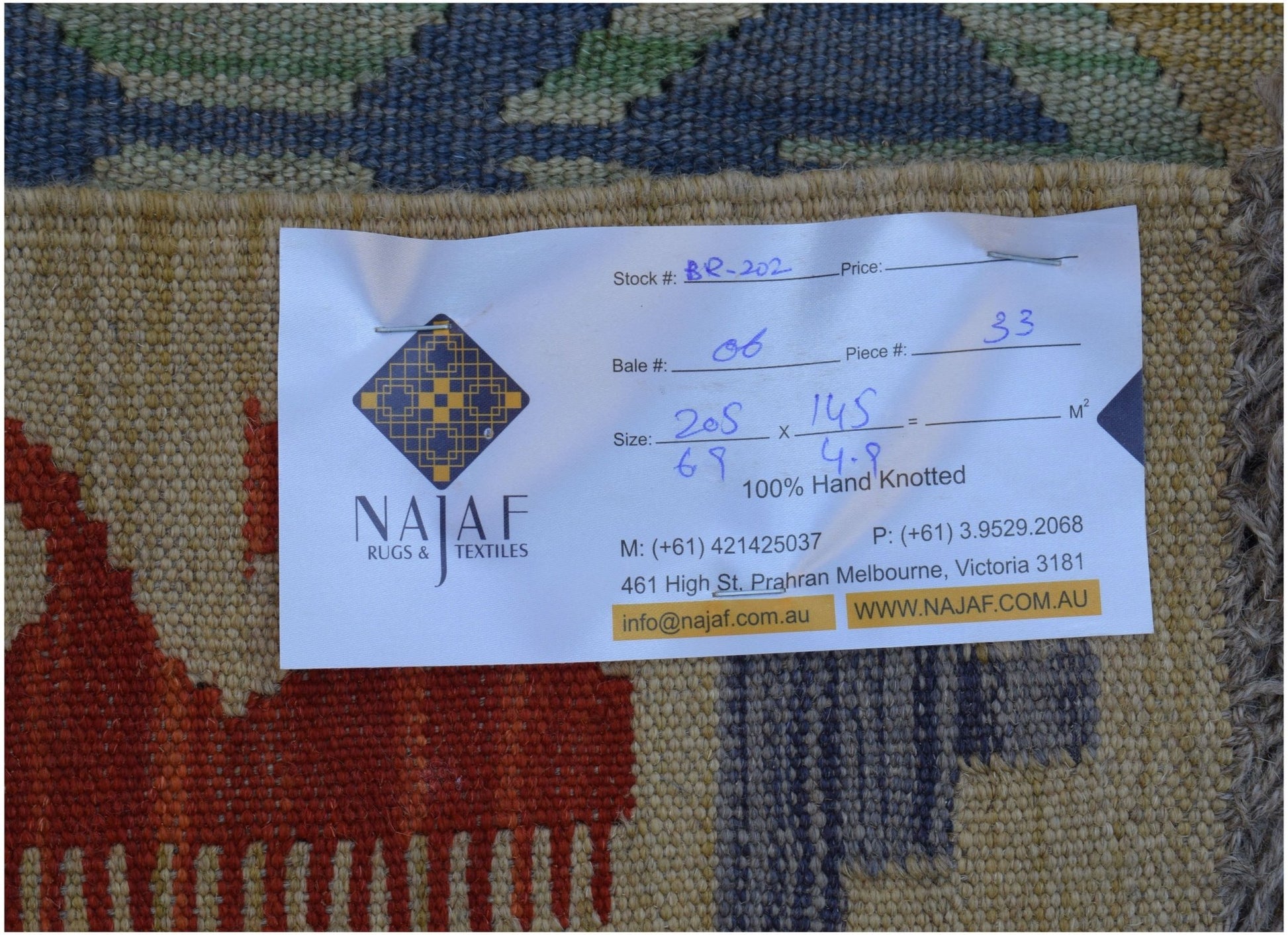 A handwoven Afghan Maimana Kilim rug featuring a flatweave texture and geometric patterns.