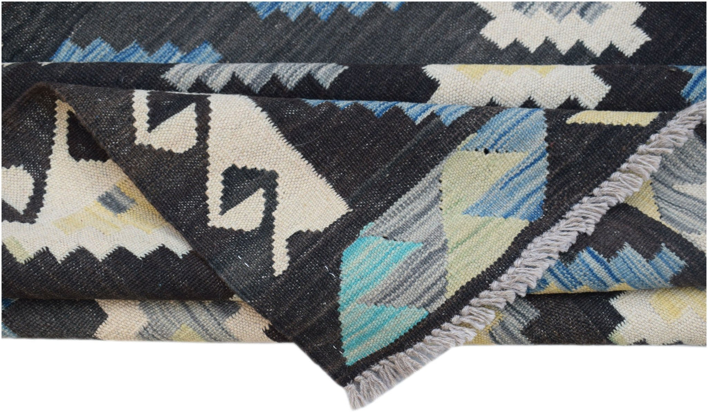 Handwoven Afghan Maimana kilim featuring a geometric pattern in black, blue, and cream wool.