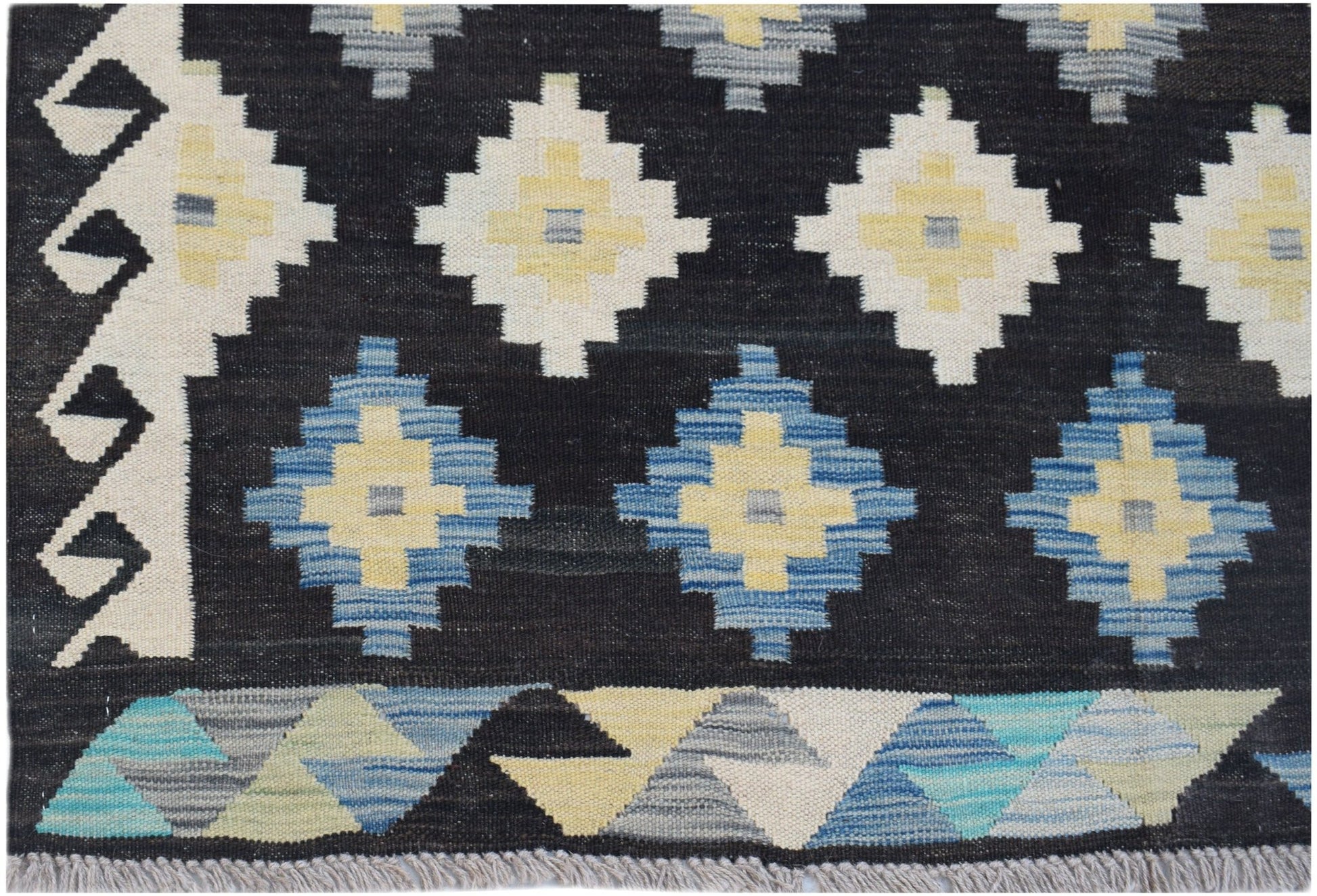 Handwoven Afghan Maimana kilim featuring a black background with geometric diamond patterns.
