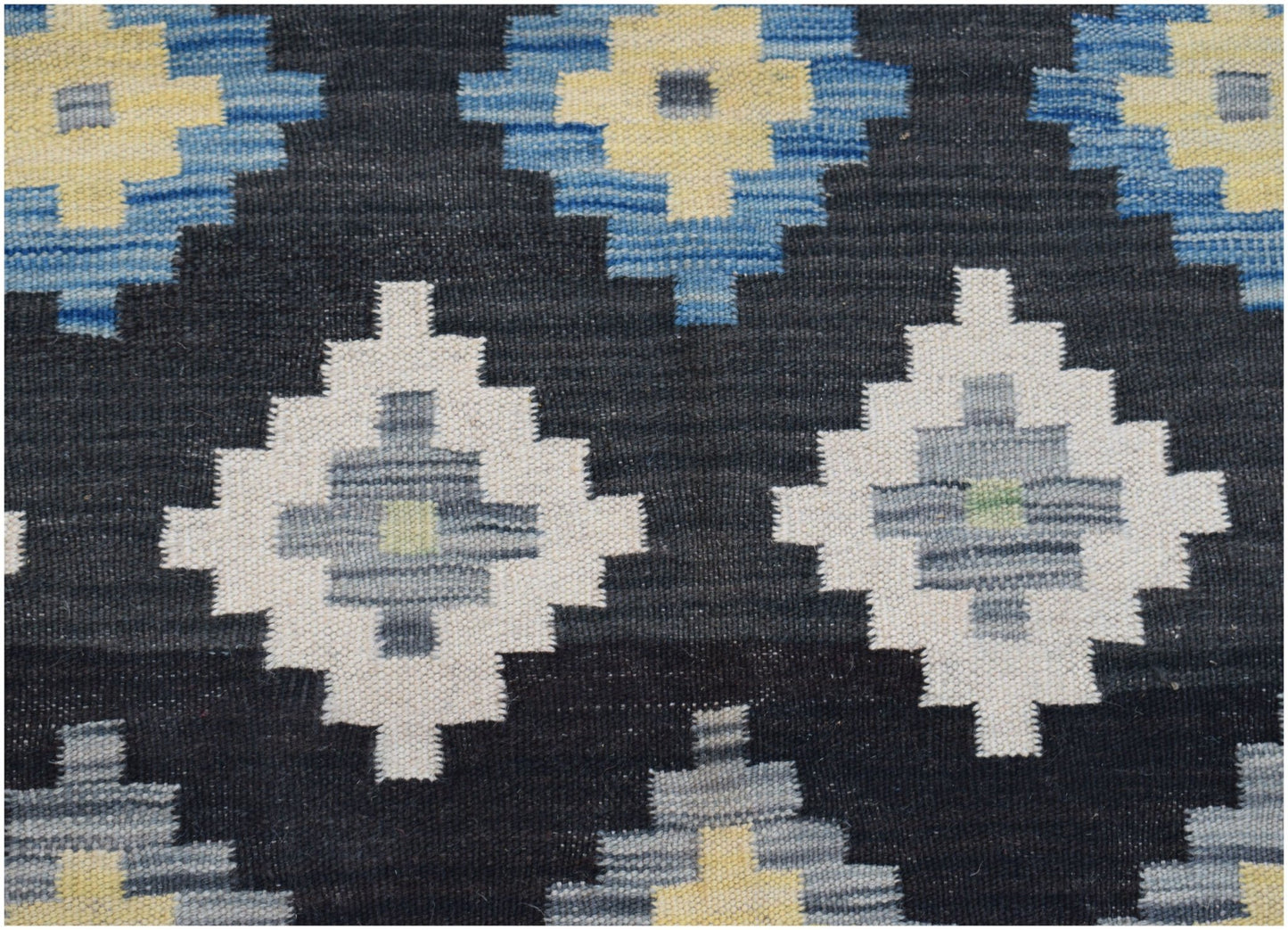 Handwoven Afghan Maimana kilim featuring a geometric diamond pattern in blue, cream, and grey.