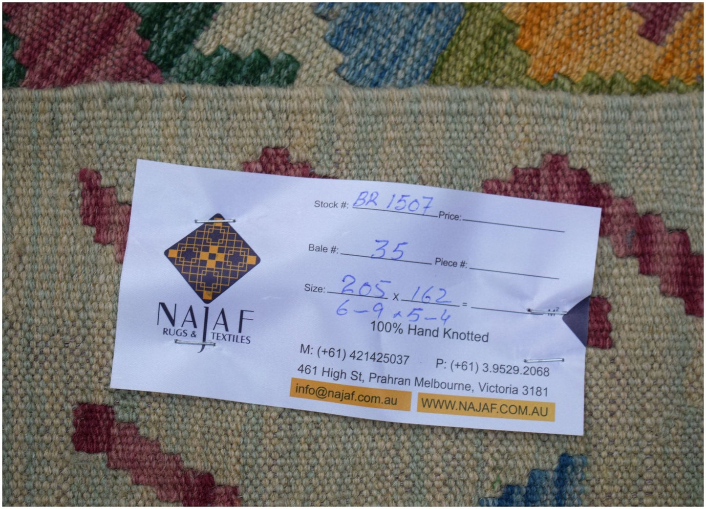 An Afghan Maimana Kilim rug featuring a flatweave texture and colorful geometric patterns.