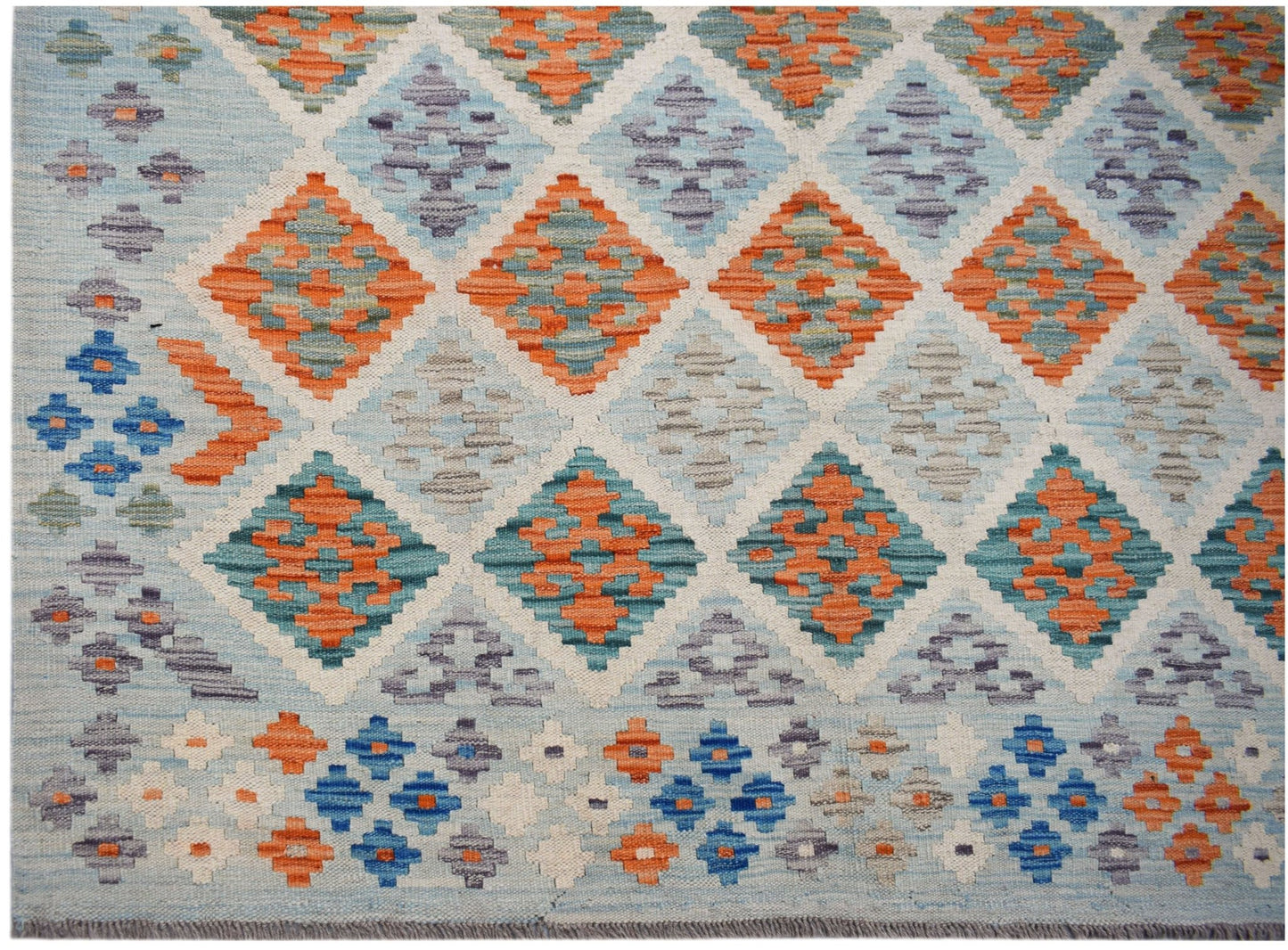 Handwoven Afghan Maimana kilim featuring a geometric diamond pattern in orange, blue, and grey.