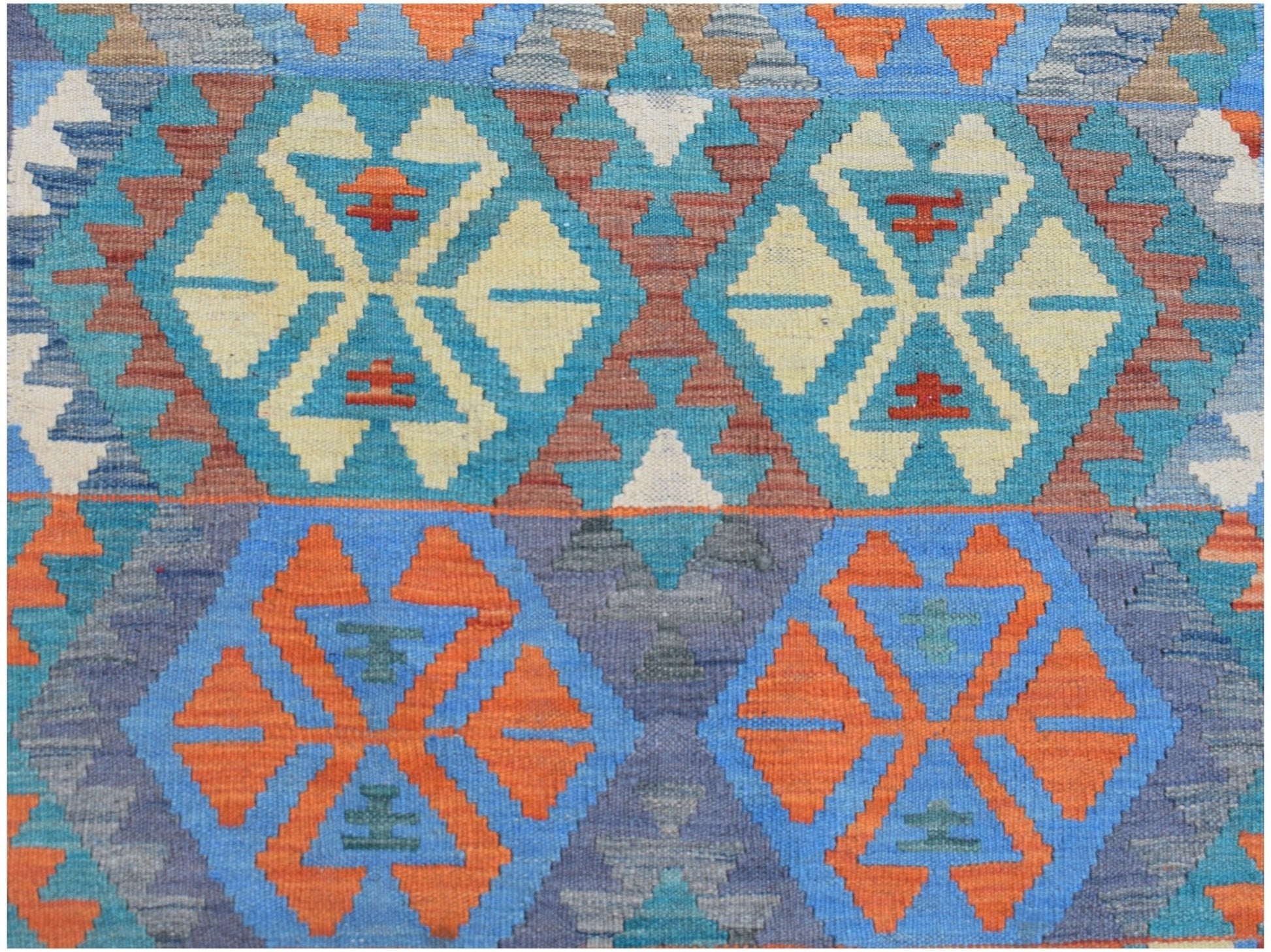 Handwoven Afghan Maimana kilim featuring a geometric pattern in blue, orange, and cream tones.