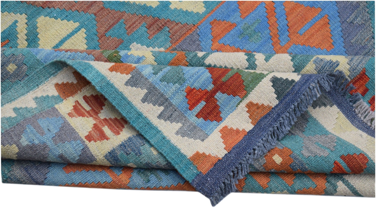 A handwoven Afghan Maimana kilim featuring a geometric pattern in blue, orange, and cream wool.
