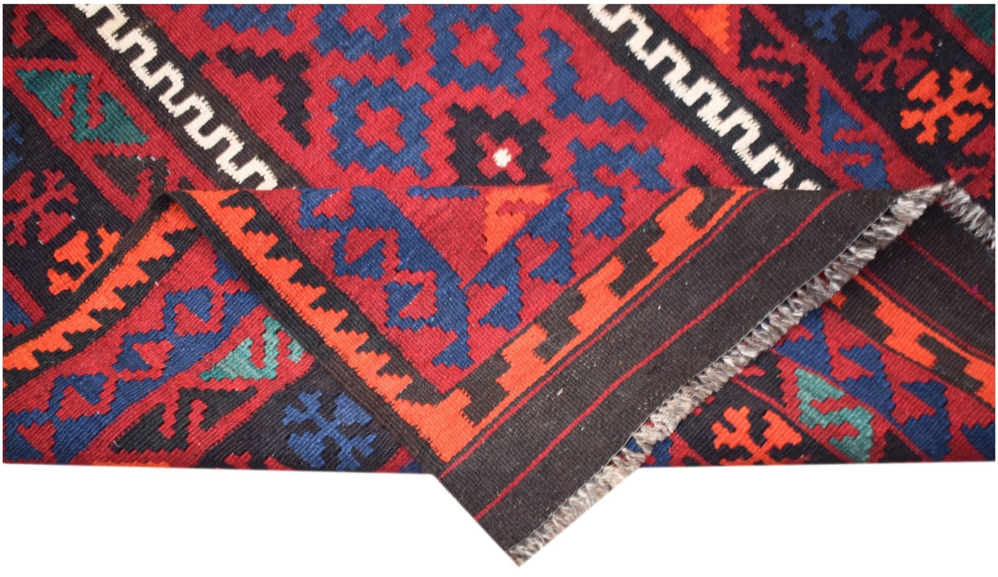 A handmade Afghan Maimana kilim featuring a geometric pattern in red, blue, and black wool.