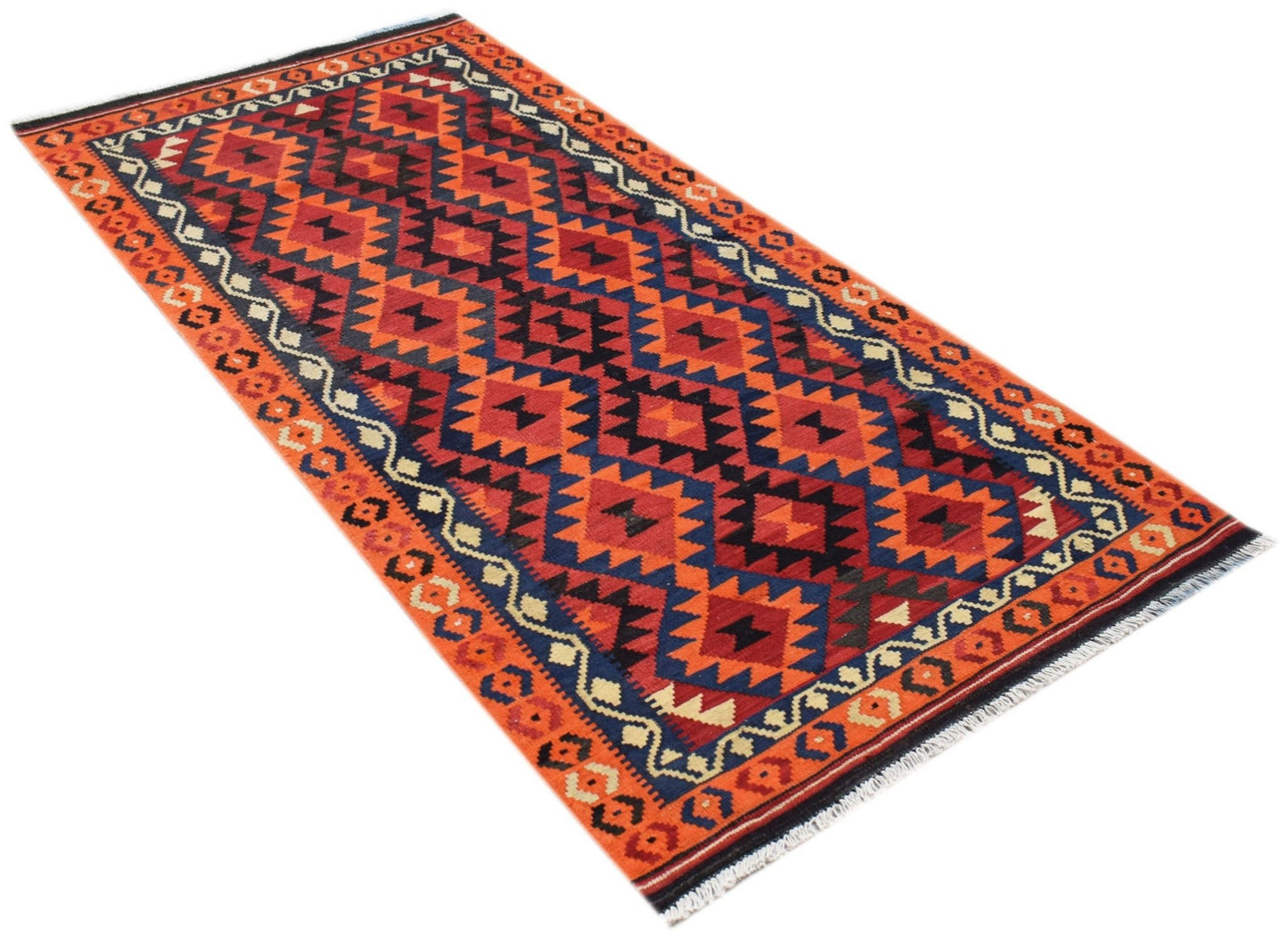 A rectangular Afghan Maimana kilim rug featuring a geometric pattern in red, blue, and cream.