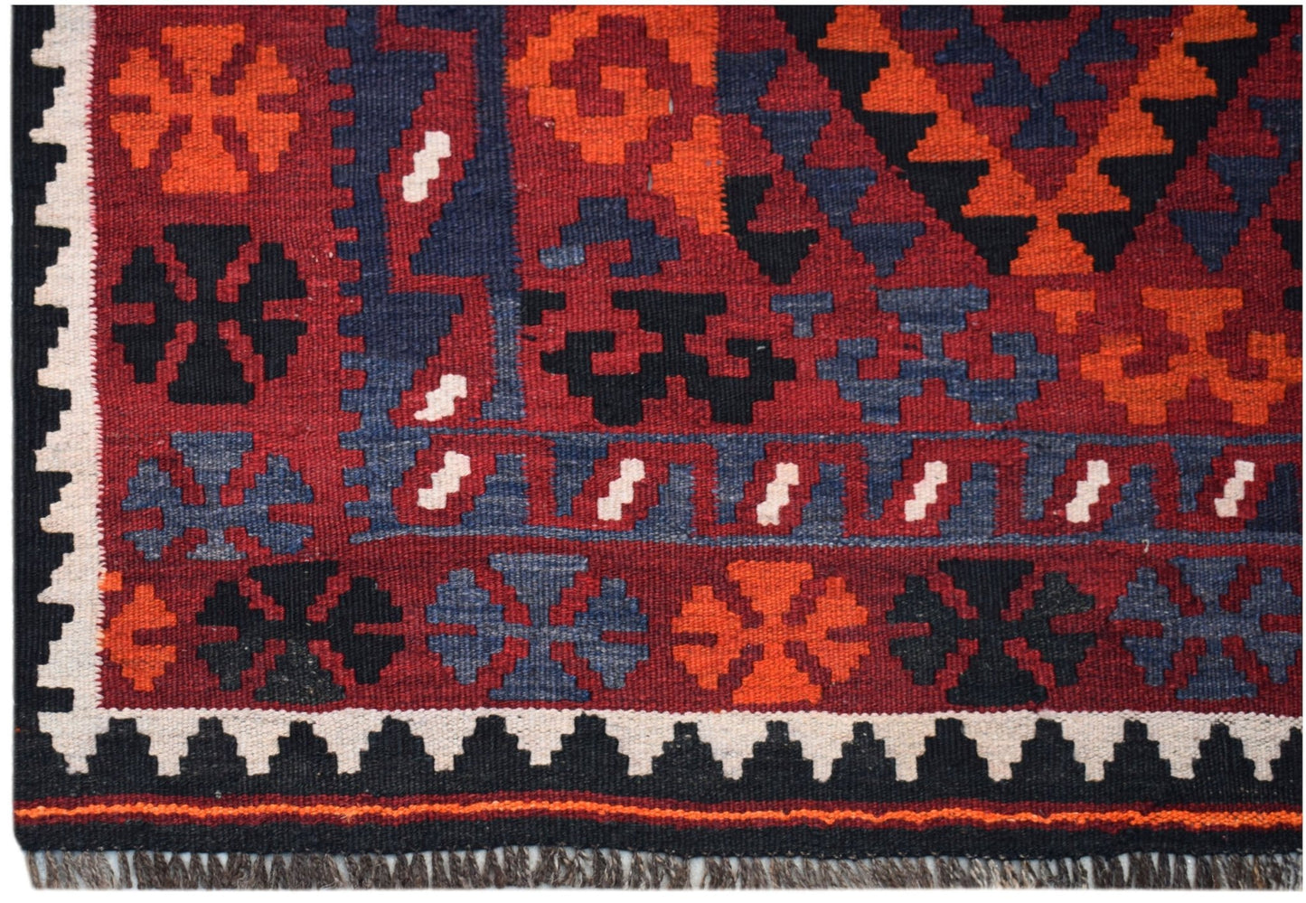 Handwoven Afghan Maimana kilim featuring geometric patterns in red, blue, black, and white wool.