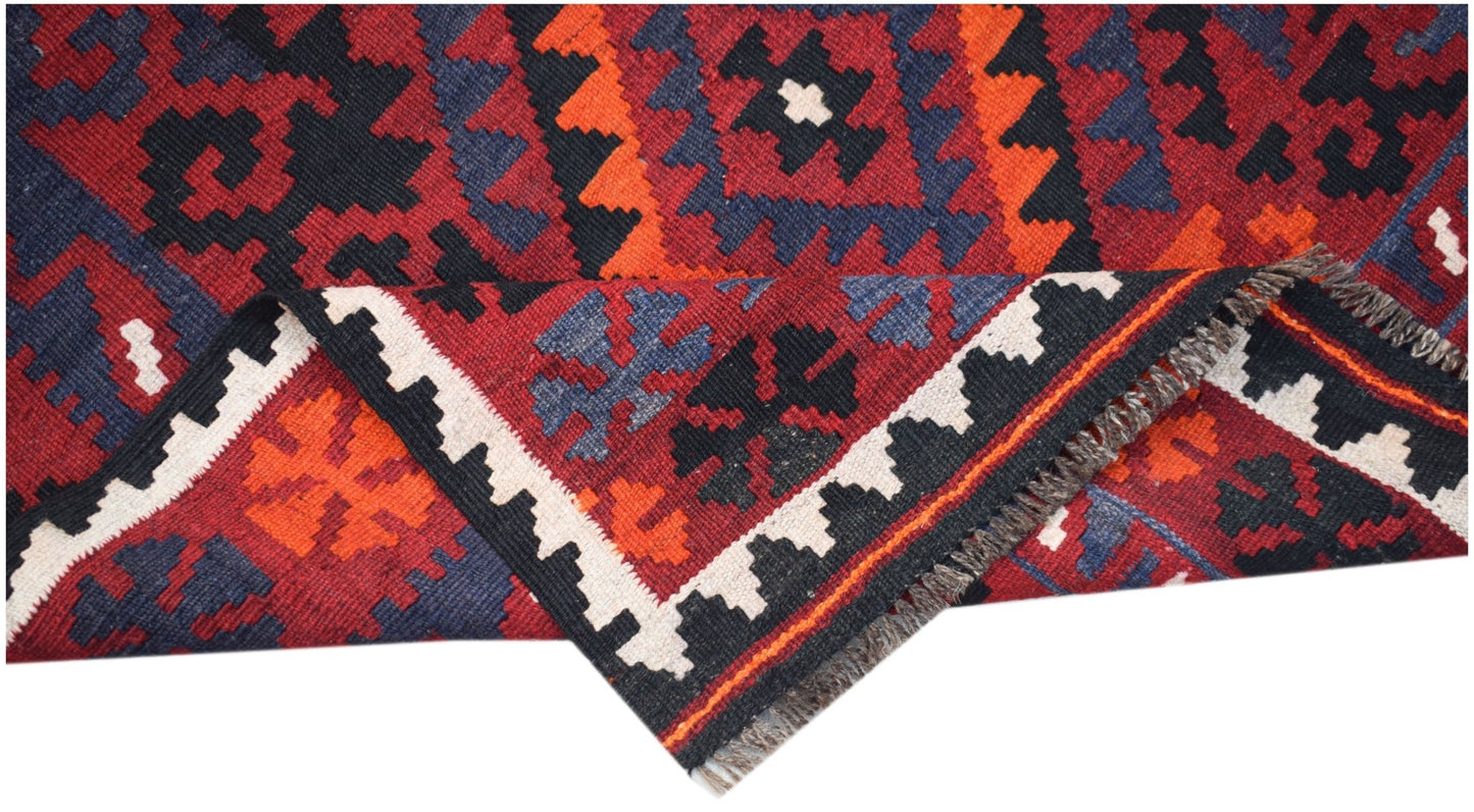 Handwoven Afghan Maimana kilim featuring a geometric pattern in red, orange, blue, and black.