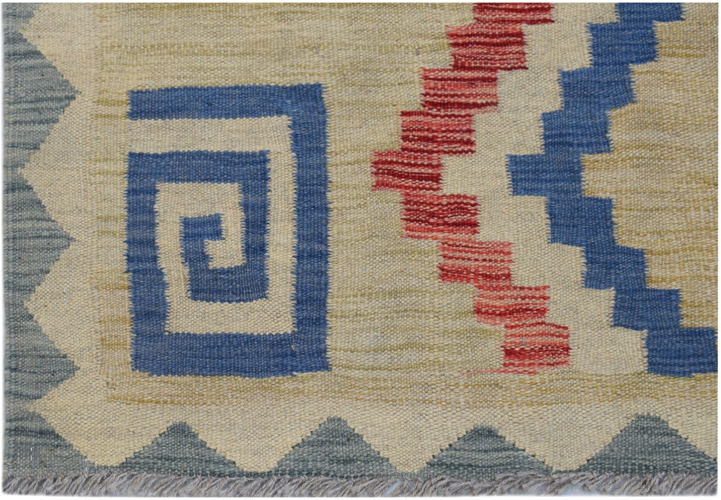 Handwoven Afghan Maimana kilim featuring a geometric blue spiral and red zigzag pattern.