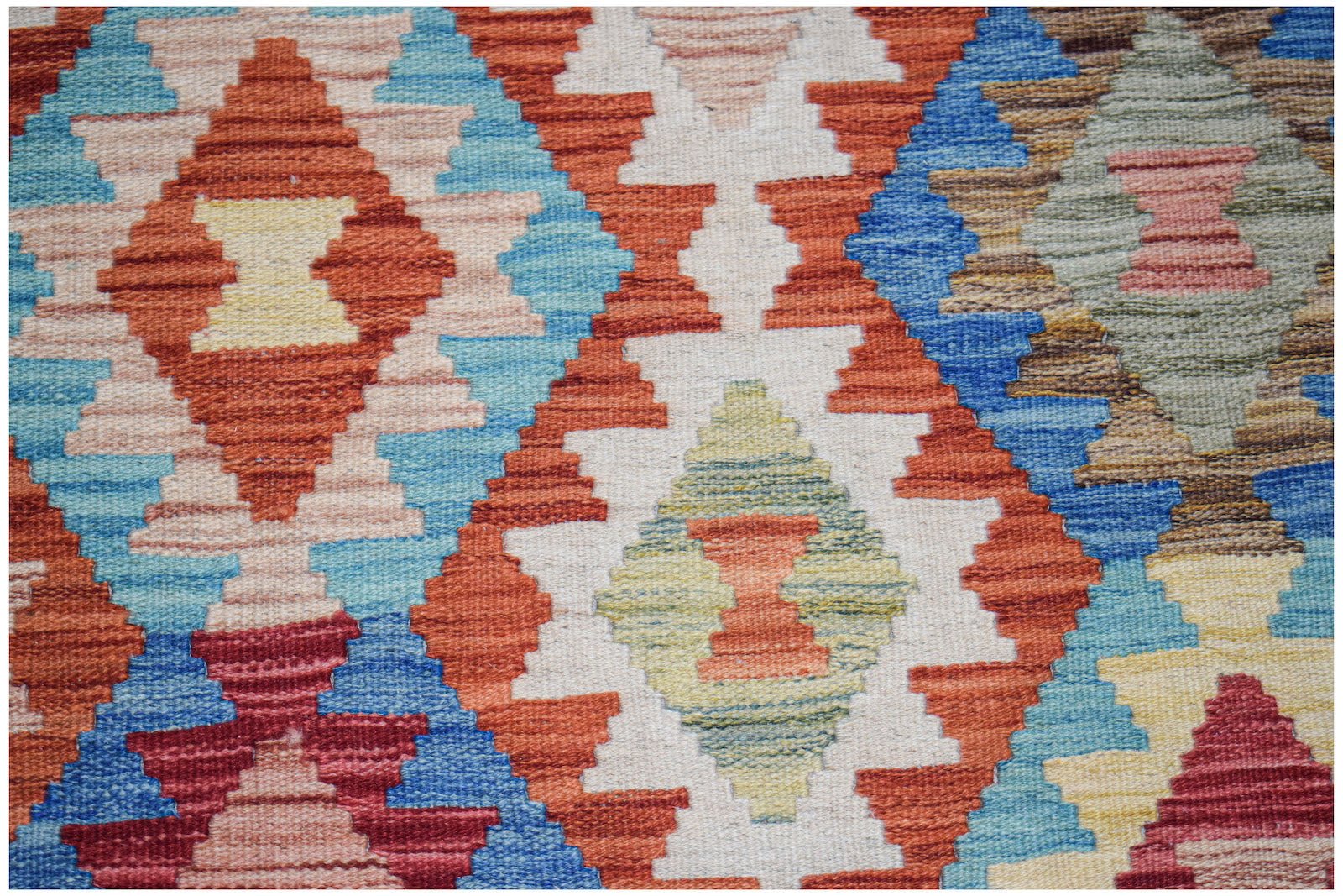 Handwoven Afghan Maimana kilim rug featuring a vibrant geometric diamond pattern in wool.