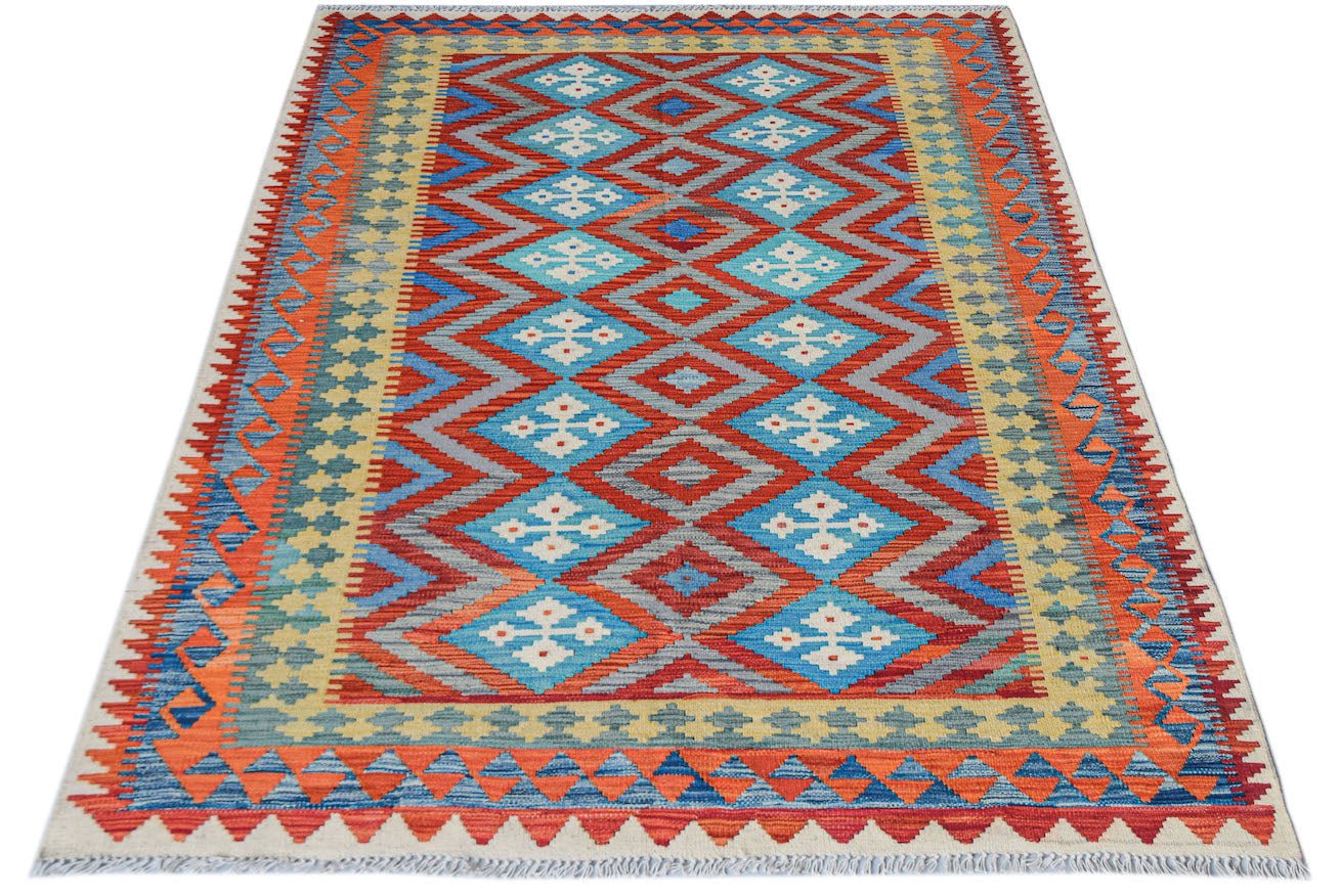 Afghan Maimana Kilim with geometric diamond patterns in red, blue, and yellow.