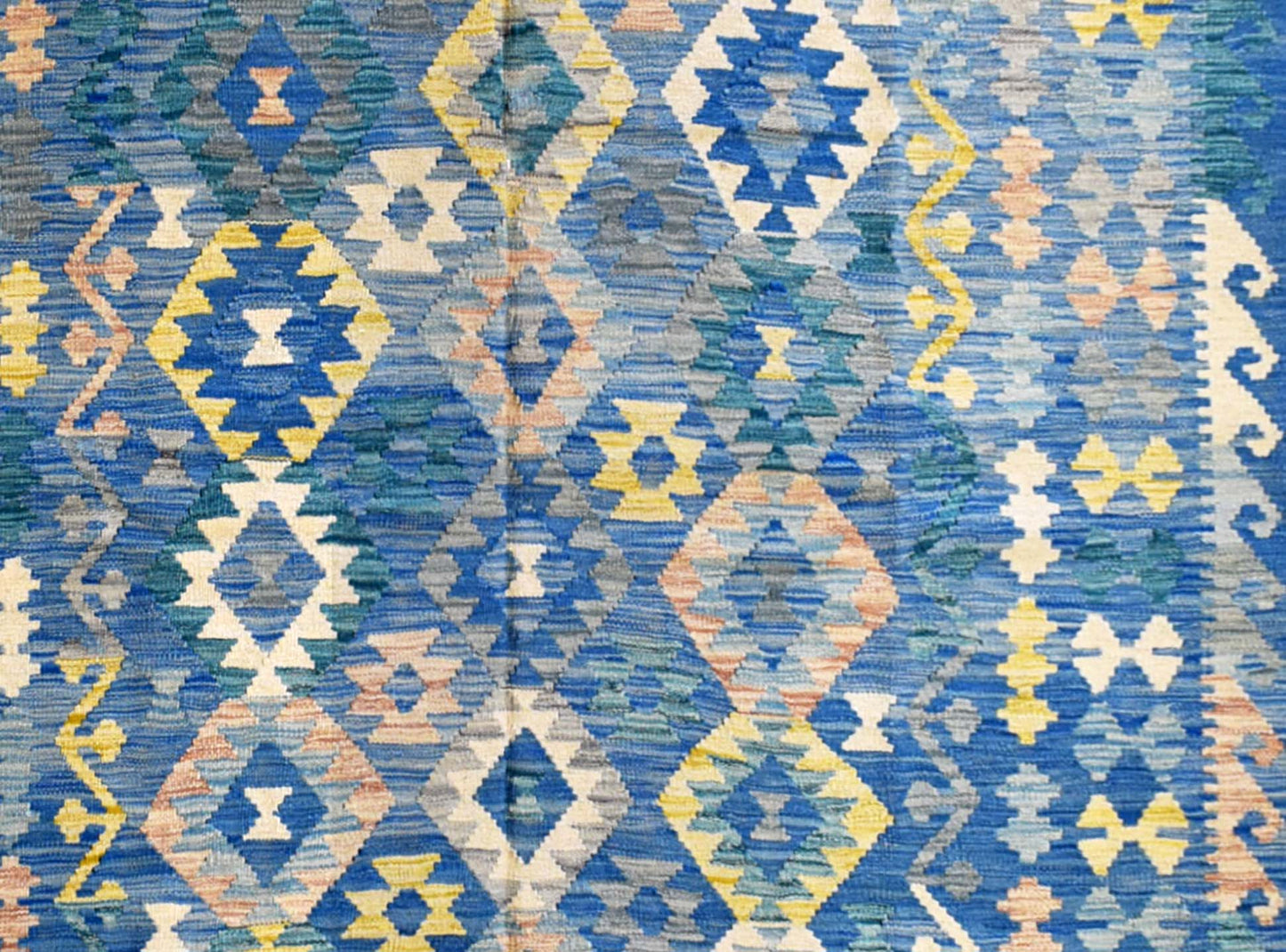 Handmade Afghan Maimana kilim rug featuring a vibrant blue geometric diamond pattern.