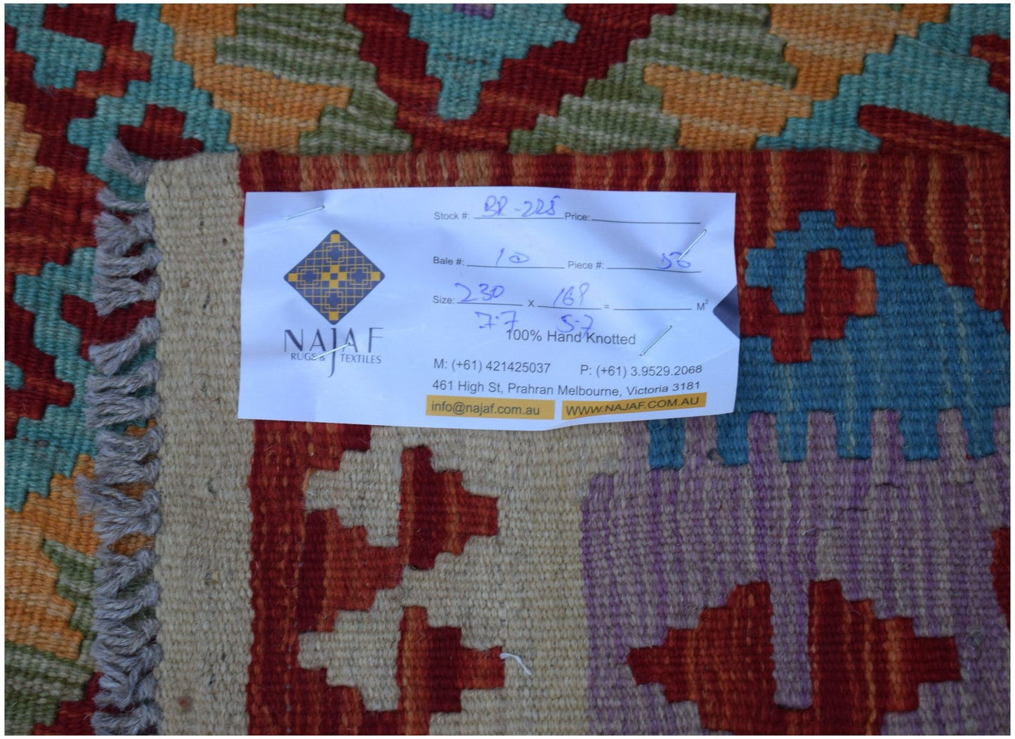 A handmade Afghan Maimana kilim featuring a vibrant geometric pattern in wool.
