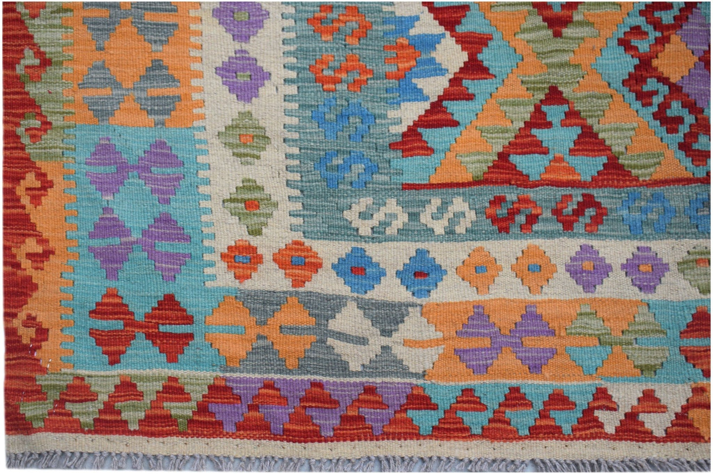 Handwoven Afghan Maimana kilim featuring a vibrant geometric pattern in wool.