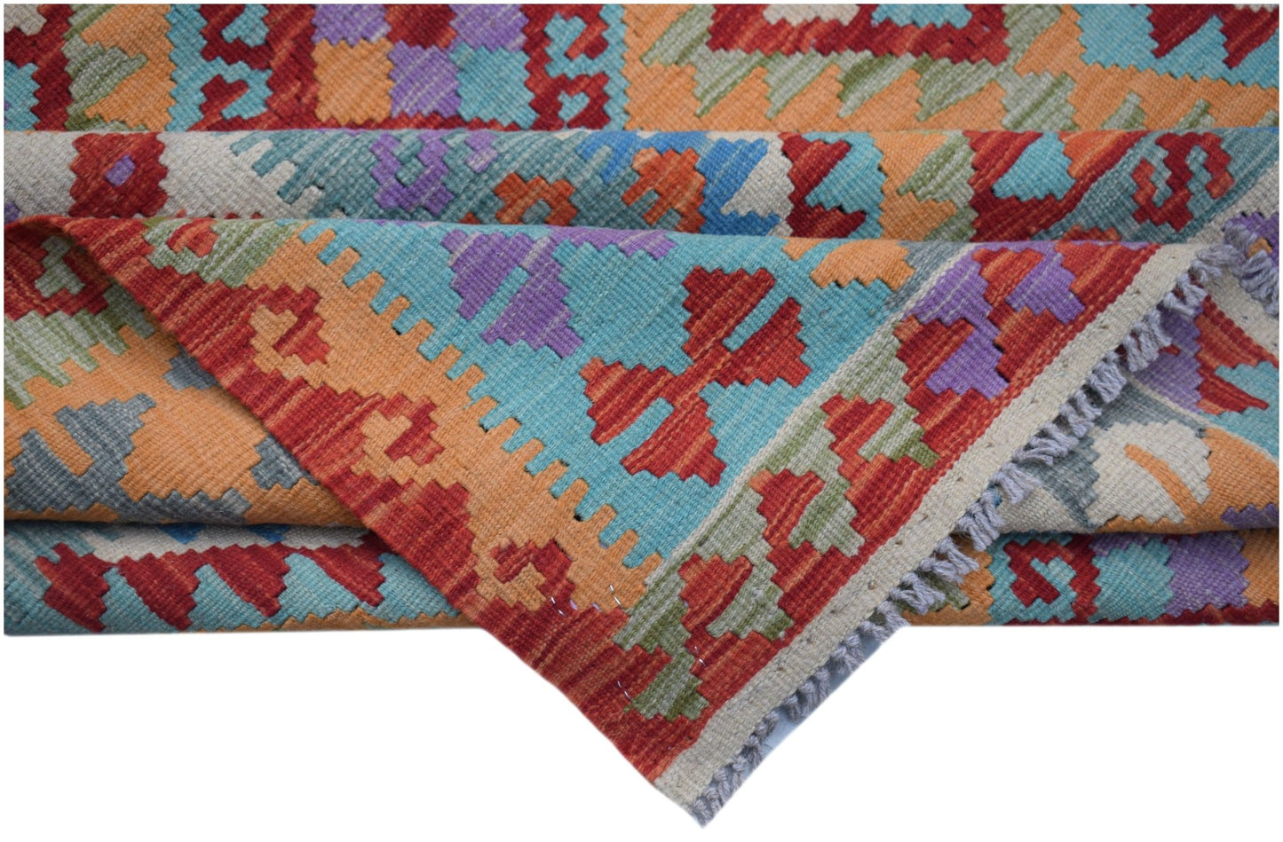 A handwoven Afghan Maimana kilim rug featuring a vibrant geometric pattern in wool.