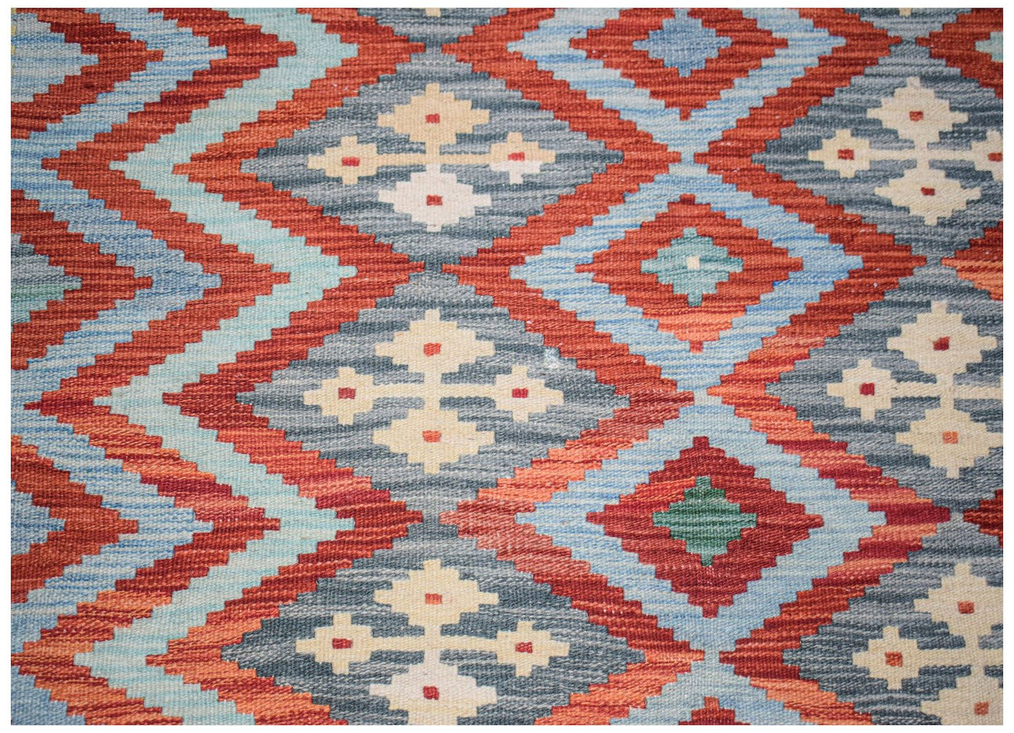 Afghan Maimana Kilim with geometric diamond patterns in red, blue, and cream.
