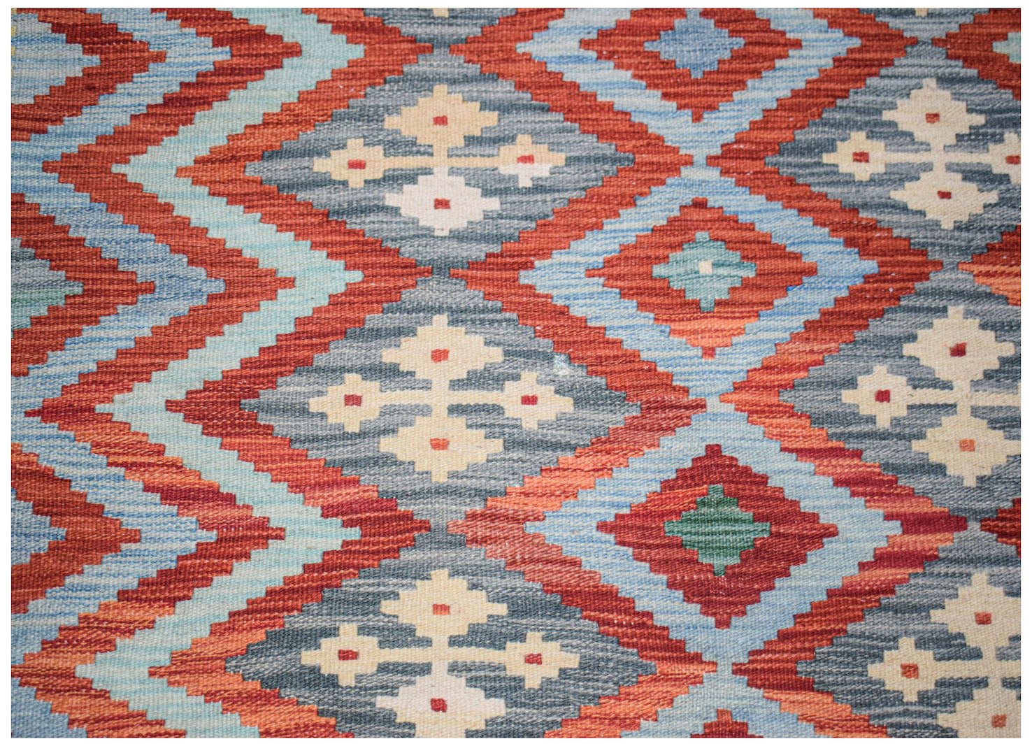 Afghan Maimana Kilim with geometric diamond patterns in red, blue, and cream.